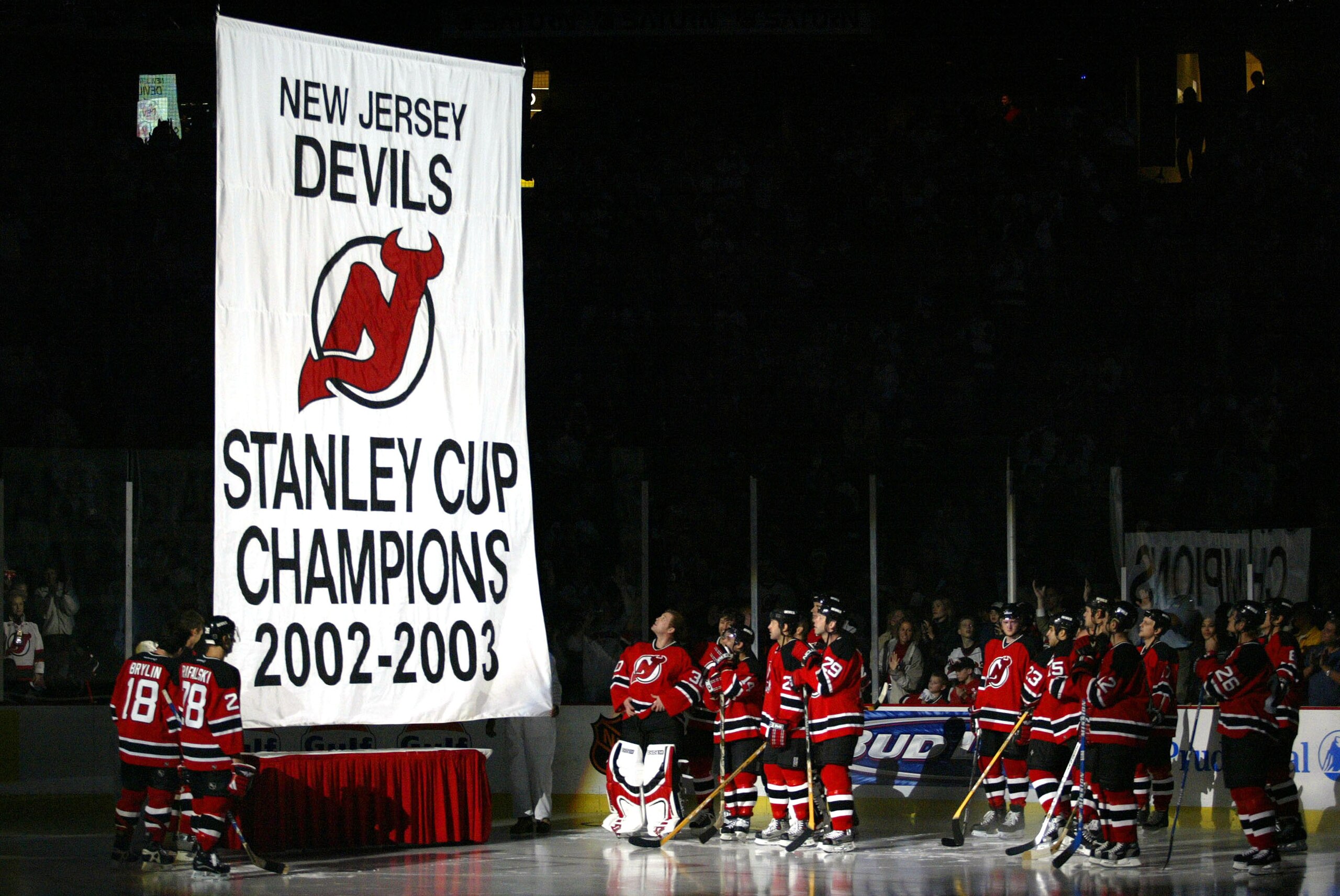 EAST RUTHERFORD, NJ - OCTOBER 16:  The  New Jersey Devils watch the raising of the banner representing their 2002-2003 Stanley Cup Championship Season before the game against the Toronto Maple Leafs October 16, 2003 at the Continental Arena in East Ruther