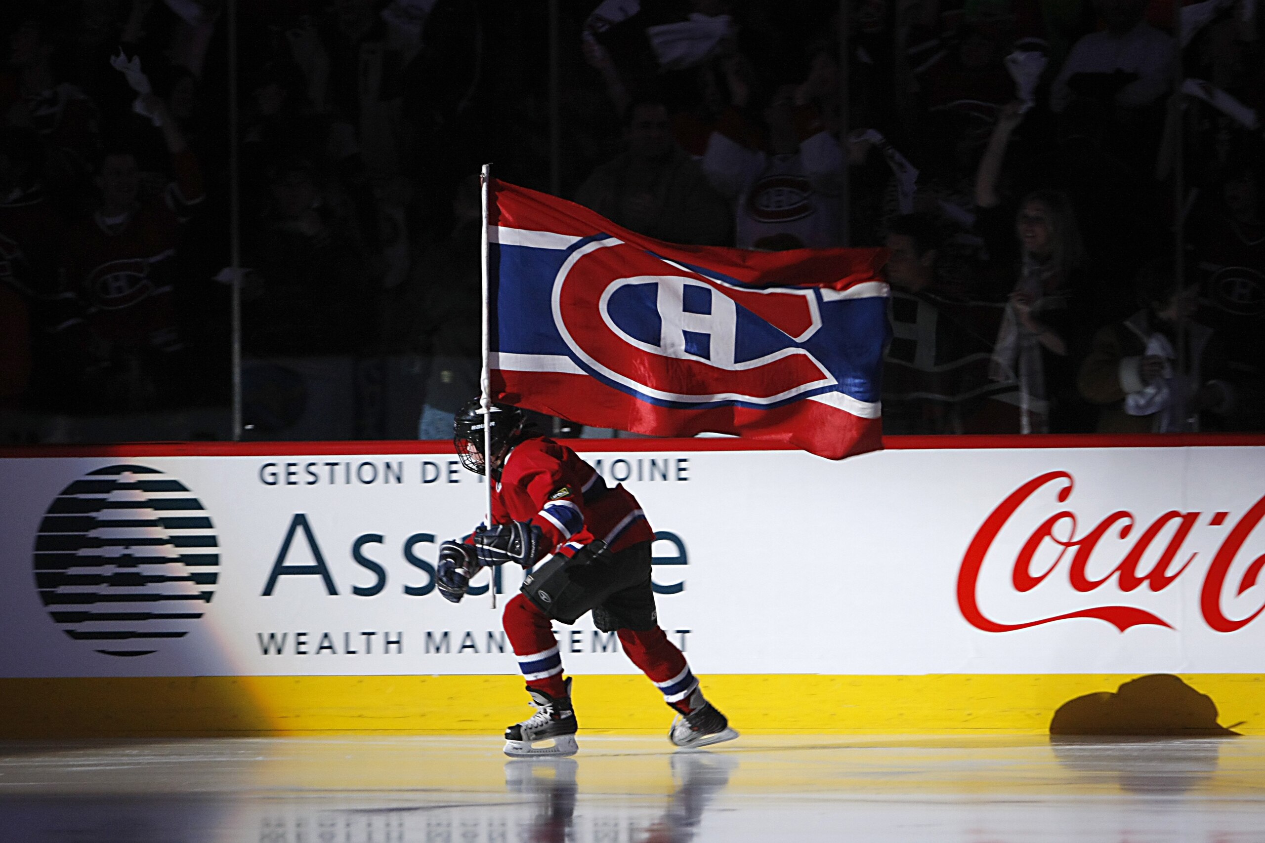 MONTREAL - APRIL 12:  A young fan of the Montreal Canadiens skates on the ice with the Canadiens flag during game two of the 2008 NHL Eastern Conference Quarterfinals against the Boston Bruins on April 12, 2008 at the Bell Centre in Montreal, Quebec.(Phot