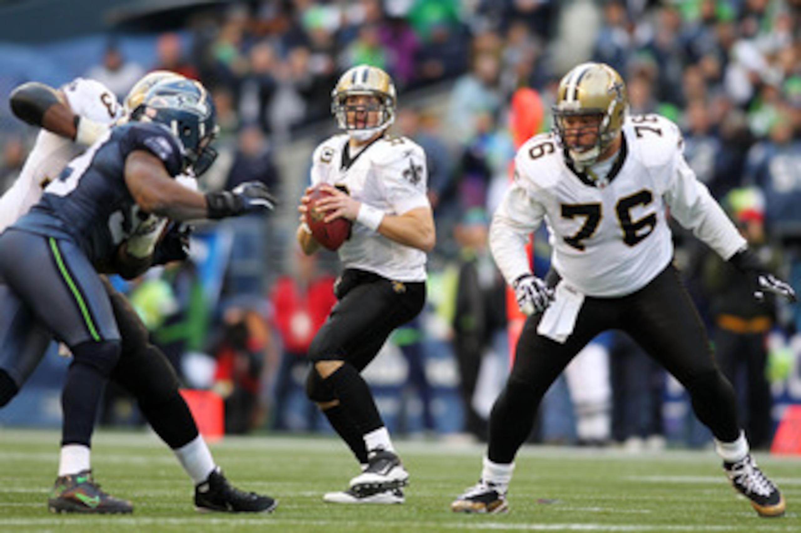 SEATTLE, WA - JANUARY 08:  Drew Brees #9 of the New Orleans Saints scrambles against the Seattle Seahawks during the 2011 NFC wild-card playoff game at Qwest Field on January 8, 2011 in Seattle, Washington.  (Photo by Jonathan Ferrey/Getty Images)