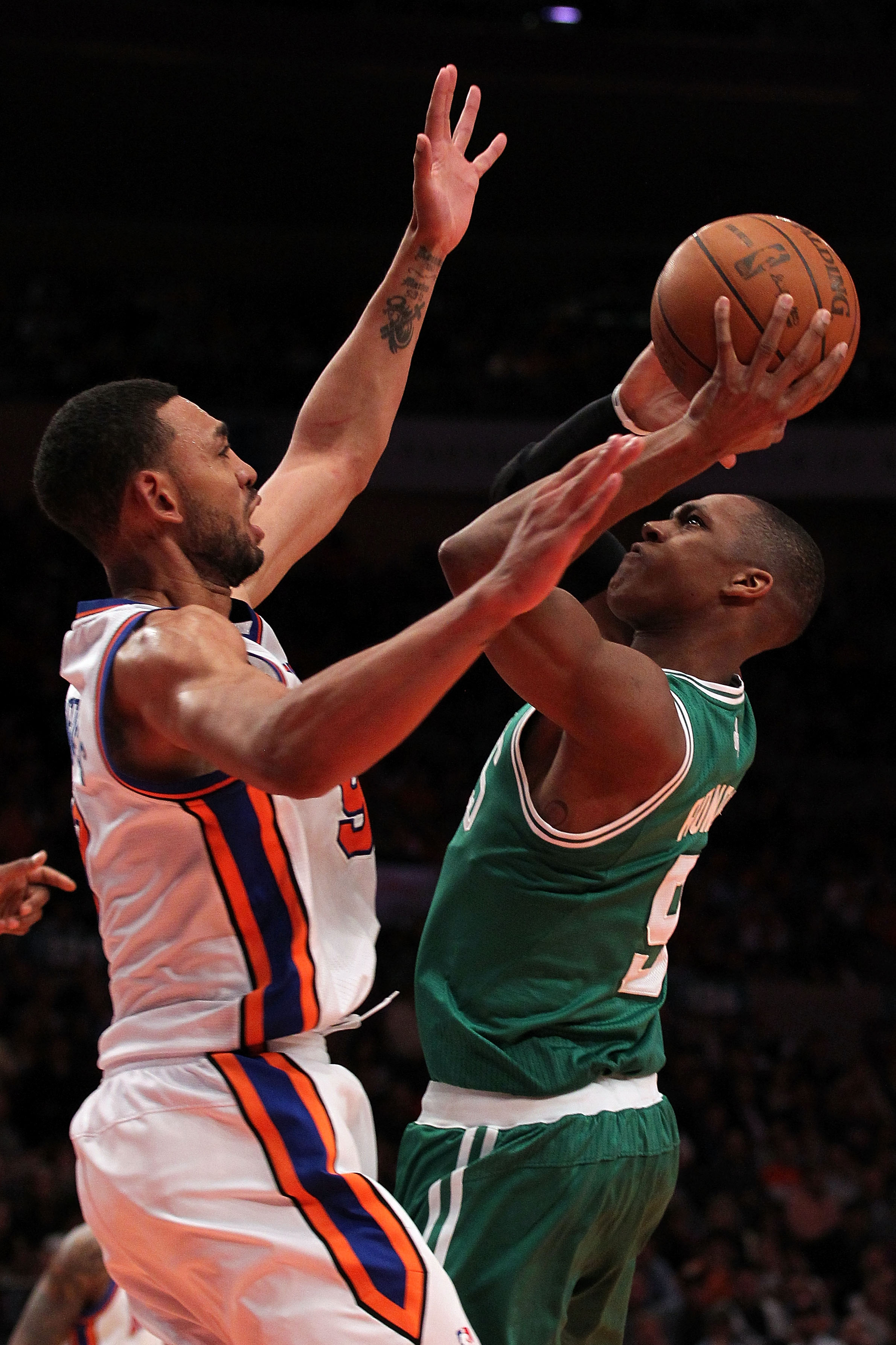 NEW YORK, NY - APRIL 22:  Rajon Rondo #9 of the Boston Celtics attempts a shot against Jared Jeffries #9 of the New York Knicks in Game Three of the Eastern Conference Quarterfinals in the 2011 NBA Playoffs on April 22, 2011 at Madison Square Garden in Ne