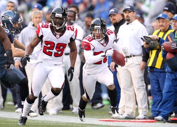 SEATTLE, WA - DECEMBER 19:  Brent Grimes #20 of the Atlanta Falcons returns an interception as Brian Williams #29 leads the block against the Seattle Seahawks at Qwest Field on December 19, 2010 in Seattle, Washington. The Falcons defeated the Seahawks 34