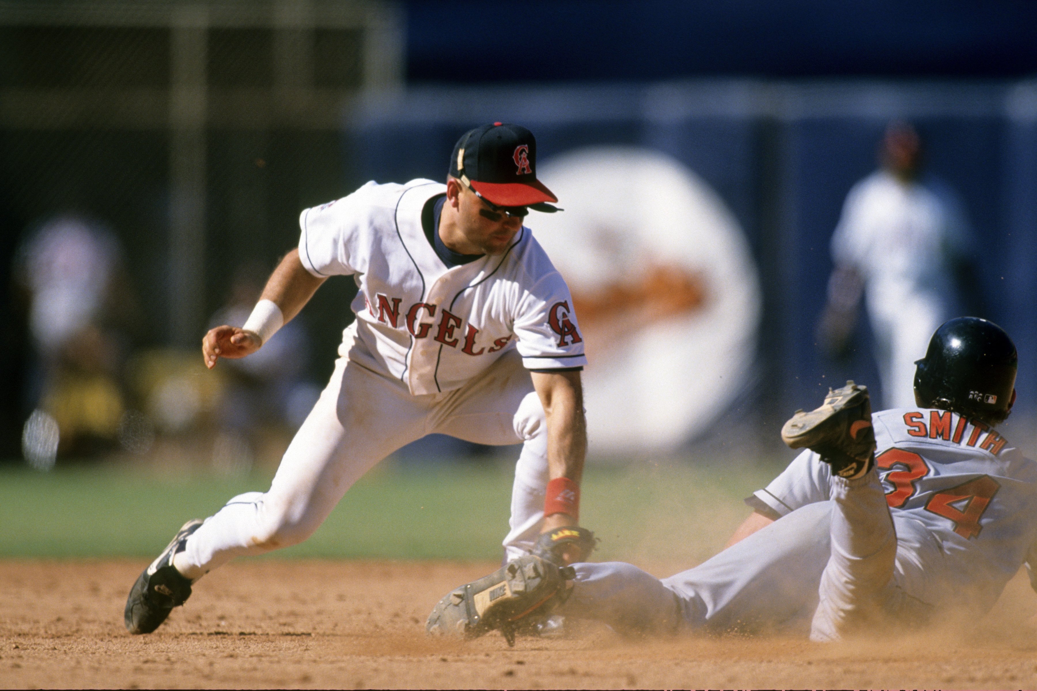 ANAHEIM, CA - AUGUST 27:  Mark Smith #34 of the Baltimore Orioles steals second against Spike Owen #17 of the California Angels during the game at Anaheim Stadium on August 27, 1995 in Anaheim, California. (Photo by Jed Jacobsohn/Getty Images)