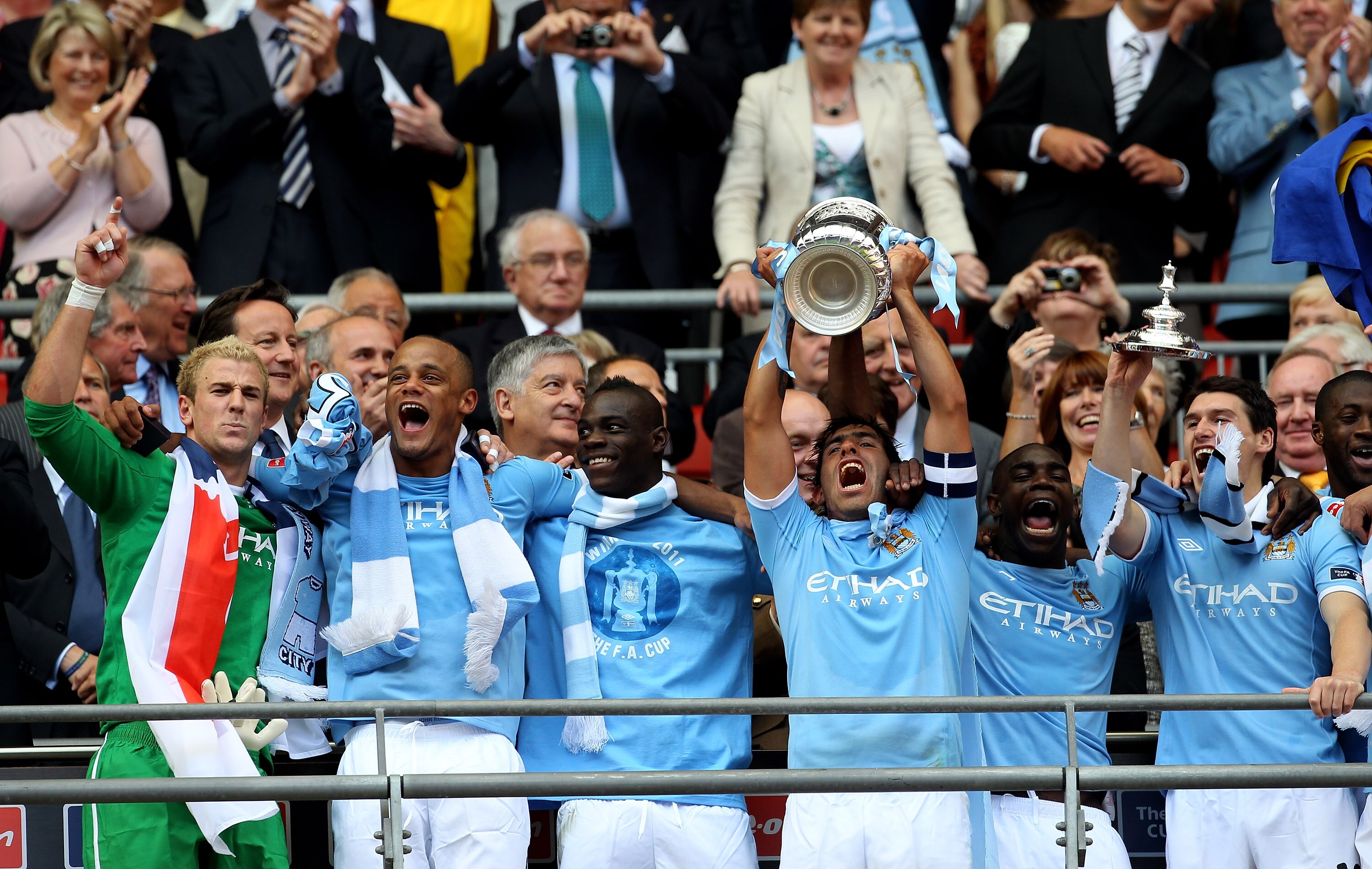 LONDON, ENGLAND - MAY 14:  Carlos Tevez lifts the trophy after he and his Manchester City team mates won the FA Cup sponsored by E.ON Final match between Manchester City and Stoke City at Wembley Stadium on May 14, 2011 in London, England.  (Photo by Alex