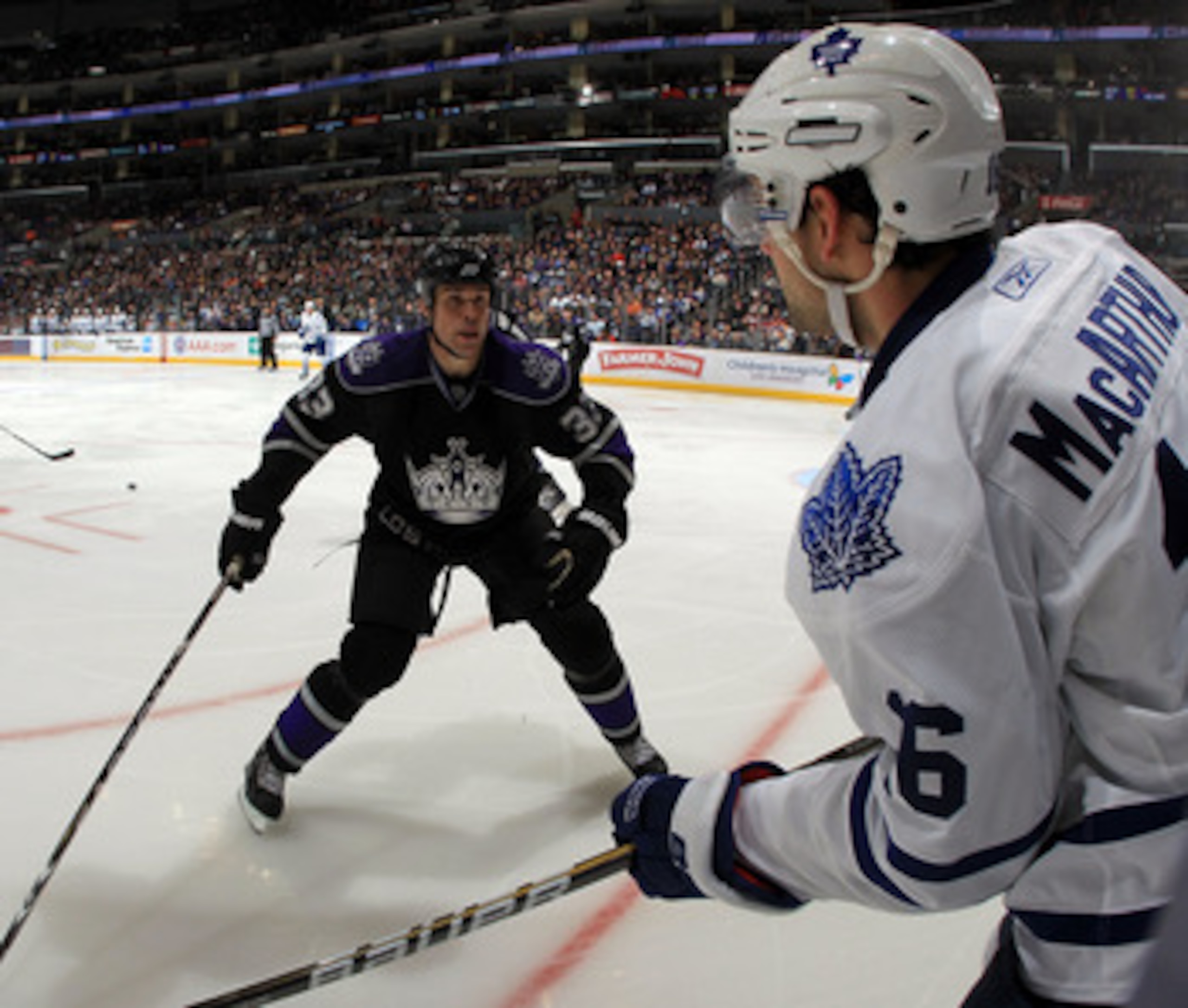 LOS ANGELES, CA - JANUARY 10: Willie Mitchell #33 of the Los Angeles Kings lines up Clarke MacArthur #16 of the Toronto Maple Leafs at the Staples Center on January 10, 2011 in Los Angeles, California. The Leafs defeated the Kings 3-2. (Photo by Bruce Ben