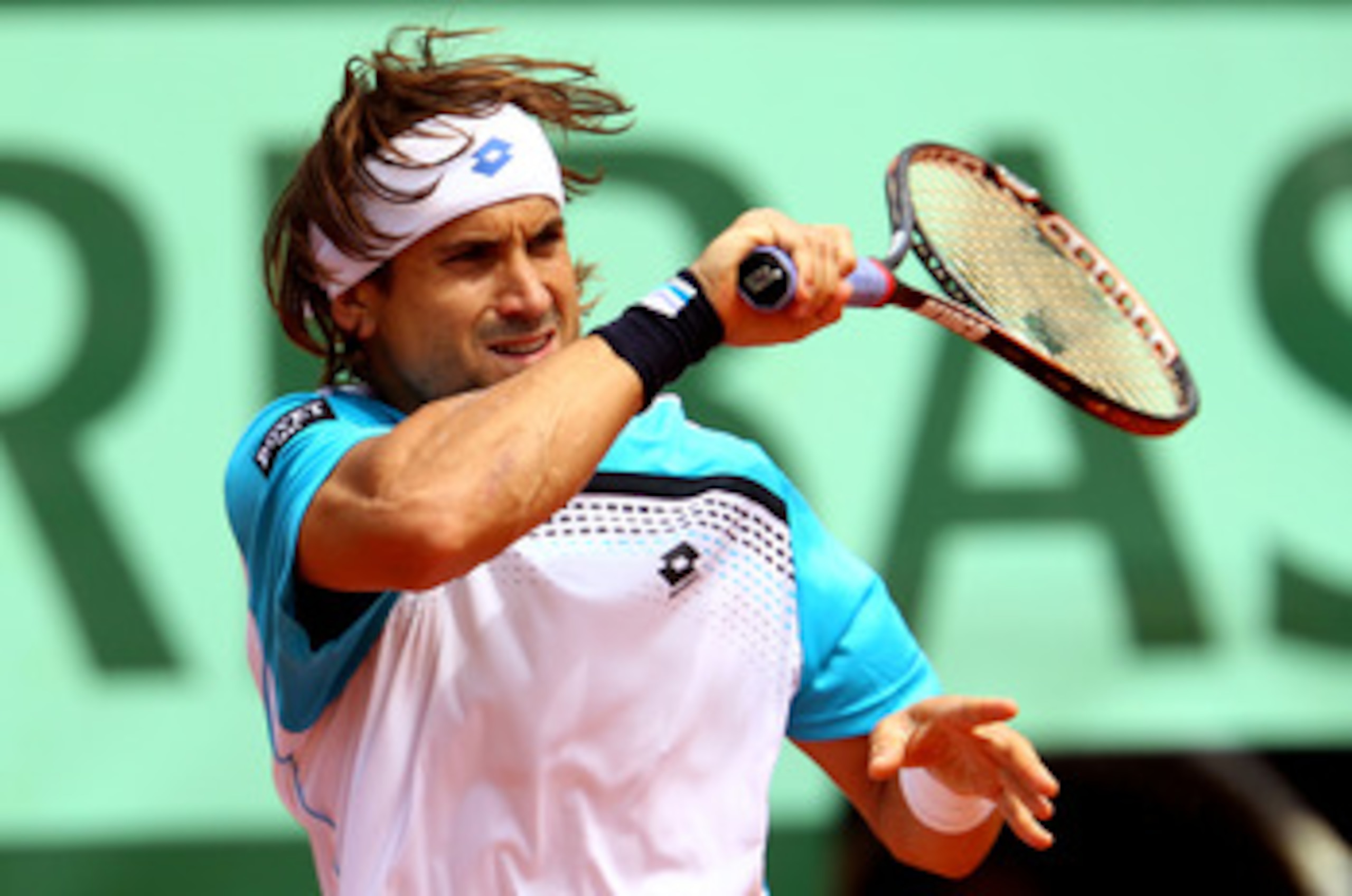 PARIS, FRANCE - MAY 22:  David Ferrer of Spain plays a forehand during the men's singles round one match  between David Ferrer of Spain and Jarkko Nieminen of Finland on day one of the French Open at Roland Garros on May 22, 2011 in Paris, France.  (Photo
