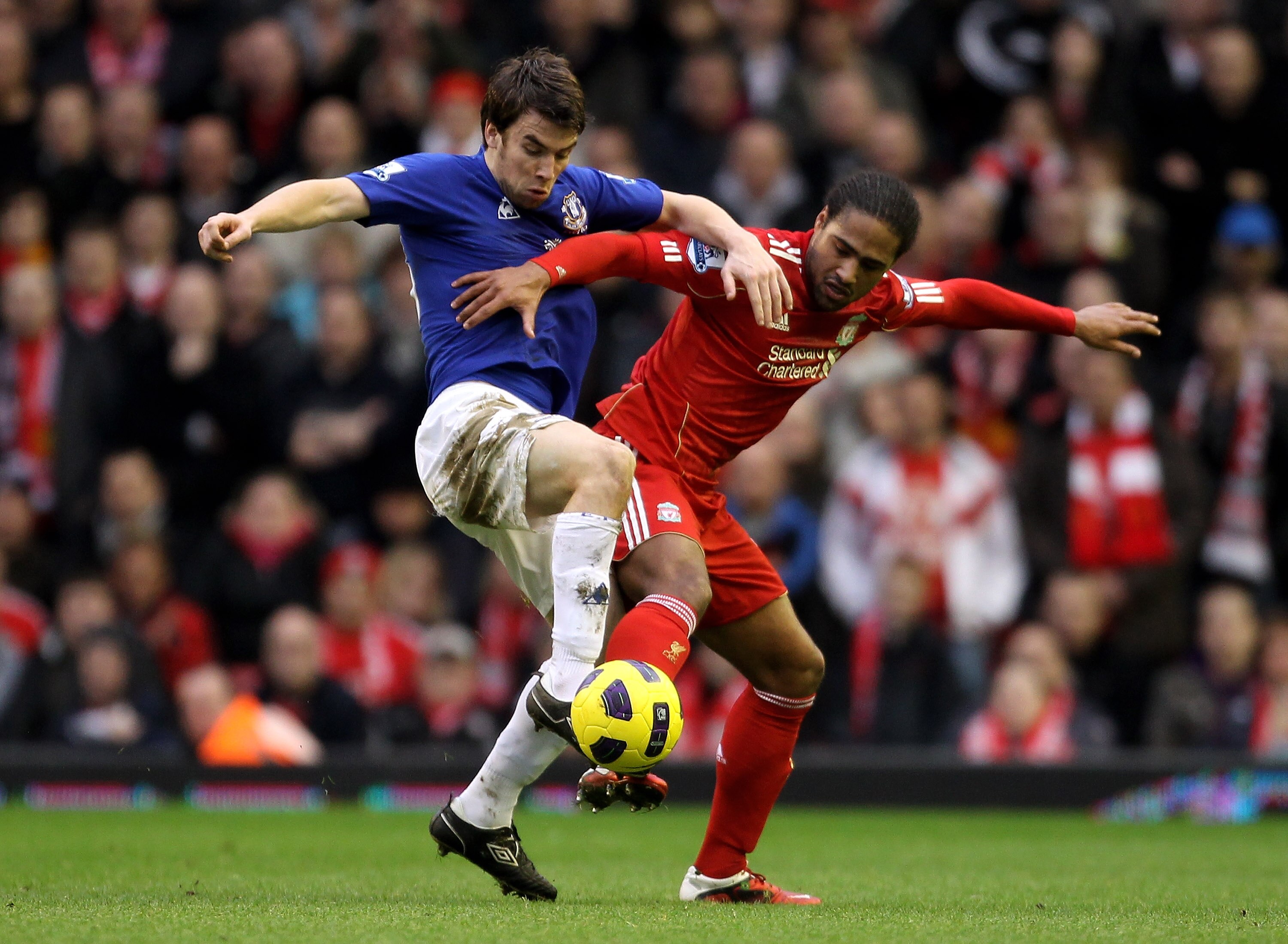 LIVERPOOL, ENGLAND - JANUARY 16:   Seamus Coleman of Everton battles for the ball with Glen Johnson of Liverpool during the Barclays Premier League match between Liverpool and Everton at Anfield on January 16, 2011 in Liverpool, England. (Photo by Alex Li