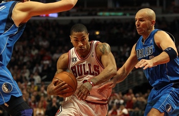 CHICAGO, IL - JANUARY 20: Derrick Rose #1 of the Chicago Bulls drives between Jason Kidd #2 and Dirk Nowitzki #41 of the Dallas Mavericks at the United Center on January 20, 2011 in Chicago, Illinois. The Bulls defeated the Mavericks 82-77. NOTE TO USER: 