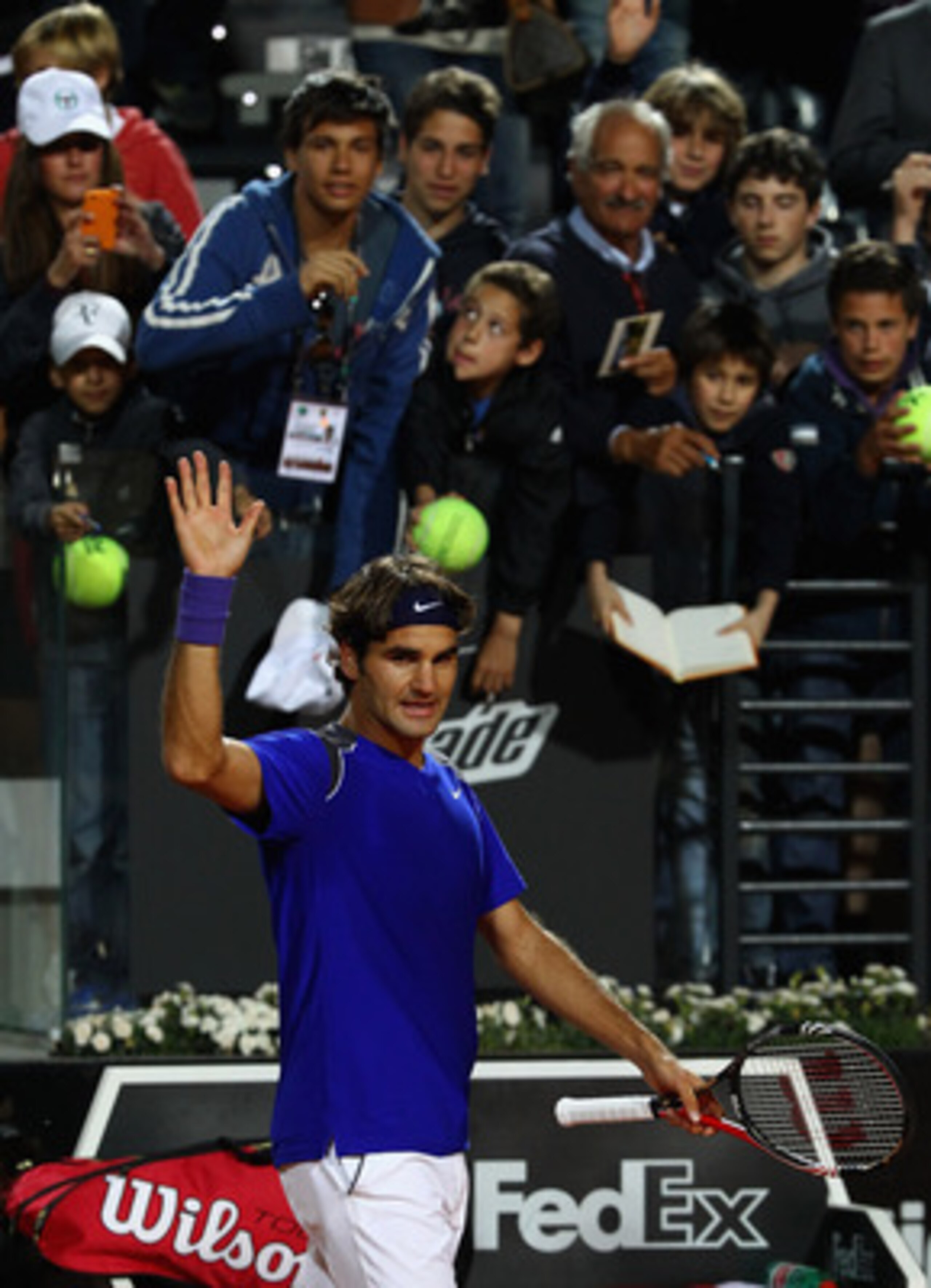 ROME, ITALY - MAY 11:  Roger Federer of Switzerland waves to the crowd after his straight sets victory in his second round match against Jo-Wilfried Tsonga of France during day four of the Internazoinali BNL D'Italia at the Foro Italico Tennis Centre on M