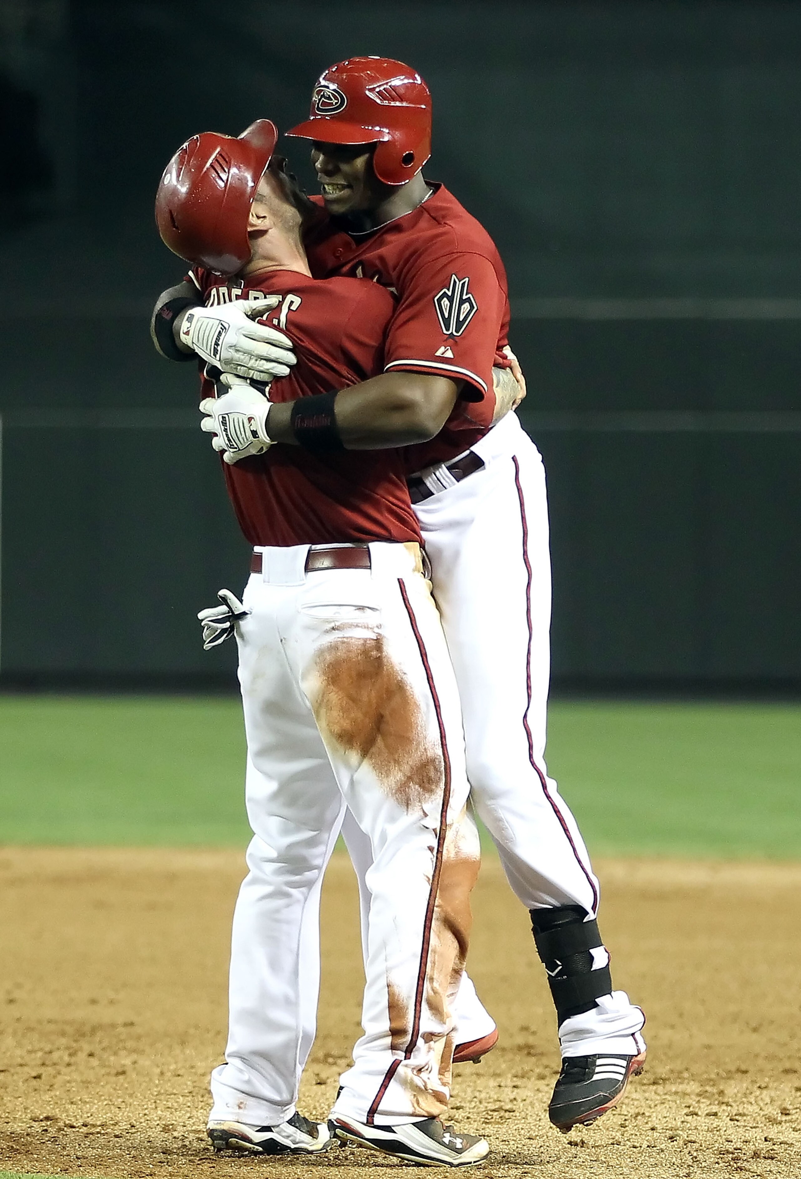 PHOENIX, AZ - MAY 18:  Justin Upton #10 and Ryan Roberts #14 of the Arizona Diamondbacks celebrate after Upton had the game winning RBI single against the Atlanta Braves in the eleventh inning of the Major League Baseball game at Chase Field on May 18, 20