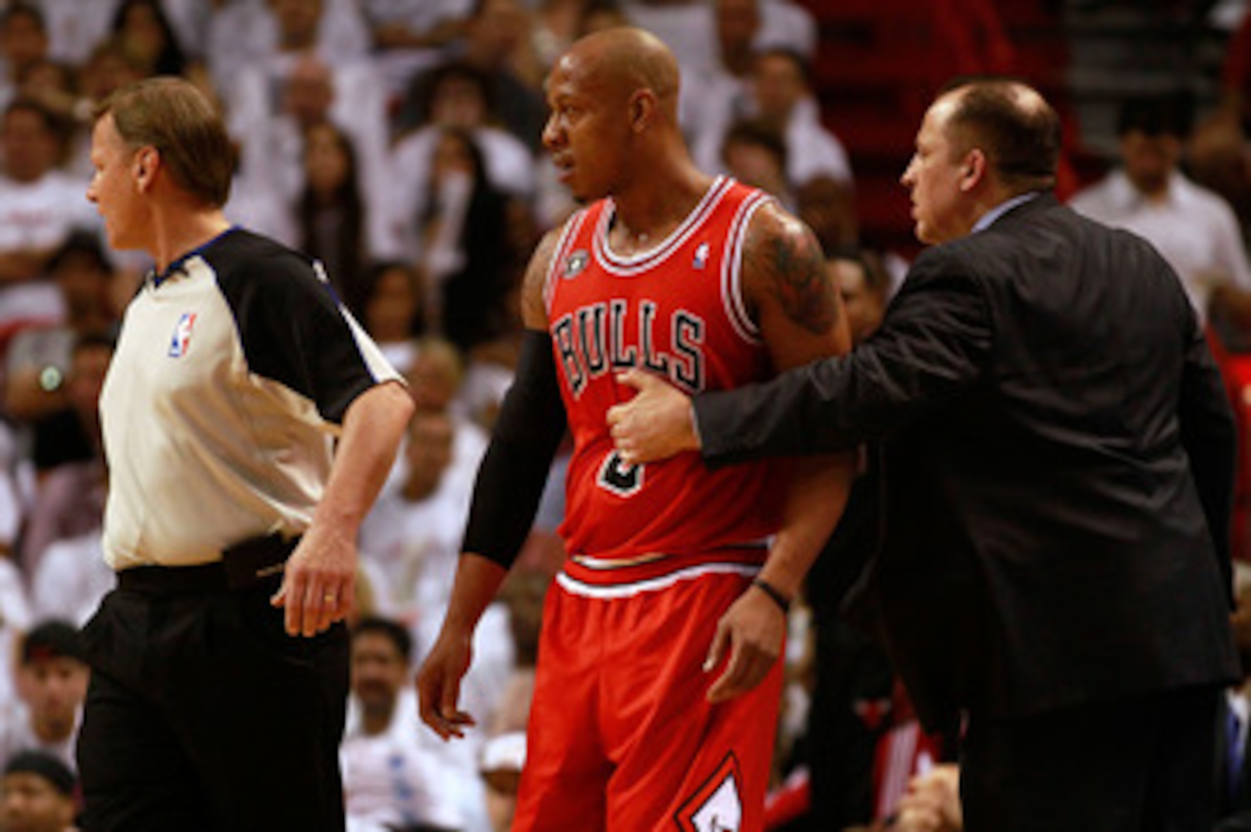 MIAMI, FL - MAY 22:  Head coach Tom Thibodeau of the Chicago Bulls holds back Keith Bogans against the Miami Heat in Game Three of the Eastern Conference Finals during the 2011 NBA Playoffs on May 22, 2011 at American Airlines Arena in Miami, Florida.  NO
