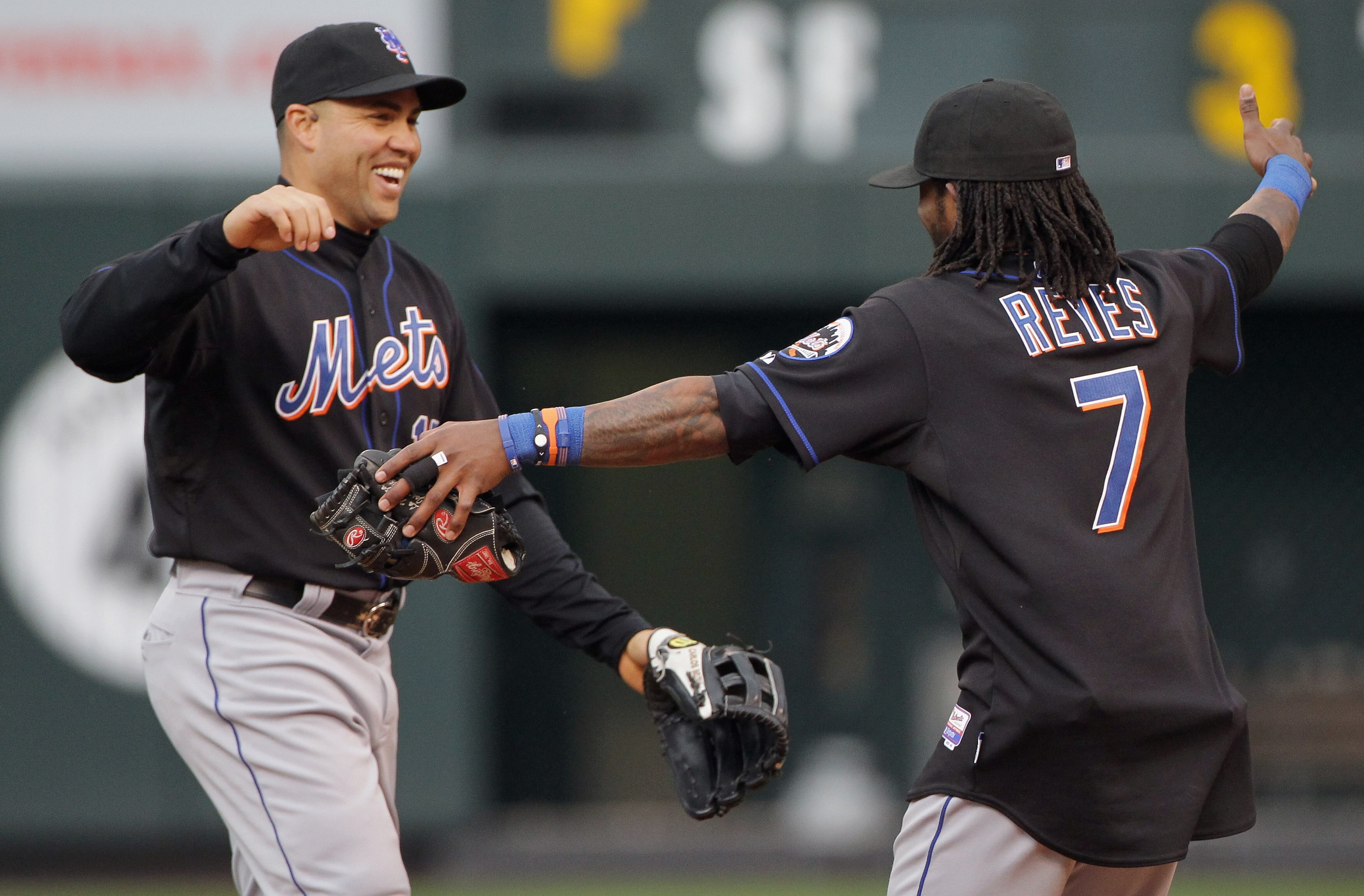 DENVER, CO - MAY 12:  Carlos Beltran #15 and Jose Reyes #7 of the New York Mets celebrate their 9-5 victory over the Colorado Rockies at Coors Field on May 12, 2011 in Denver, Colorado.  (Photo by Doug Pensinger/Getty Images)