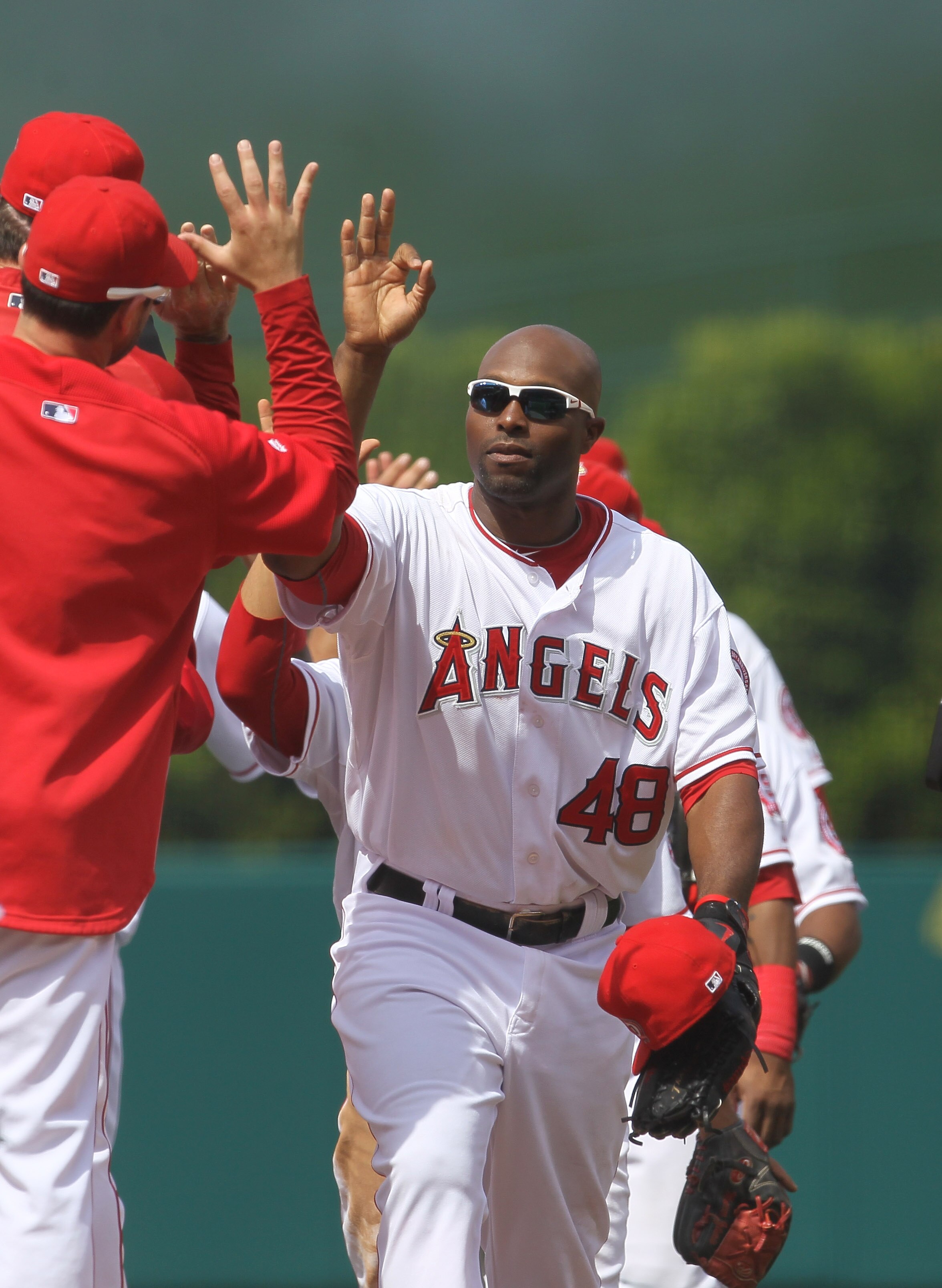 ANAHEIM, CA - MAY 22:  Torii Hunter #48 of the Los Angeles Angels of Anaheim celebrates with teammates after the game with the Atlanta Braves on May 22, 2011 at Angel Stadium in Anaheim, California.   The Angels won 4-1.  (Photo by Stephen Dunn/Getty Imag