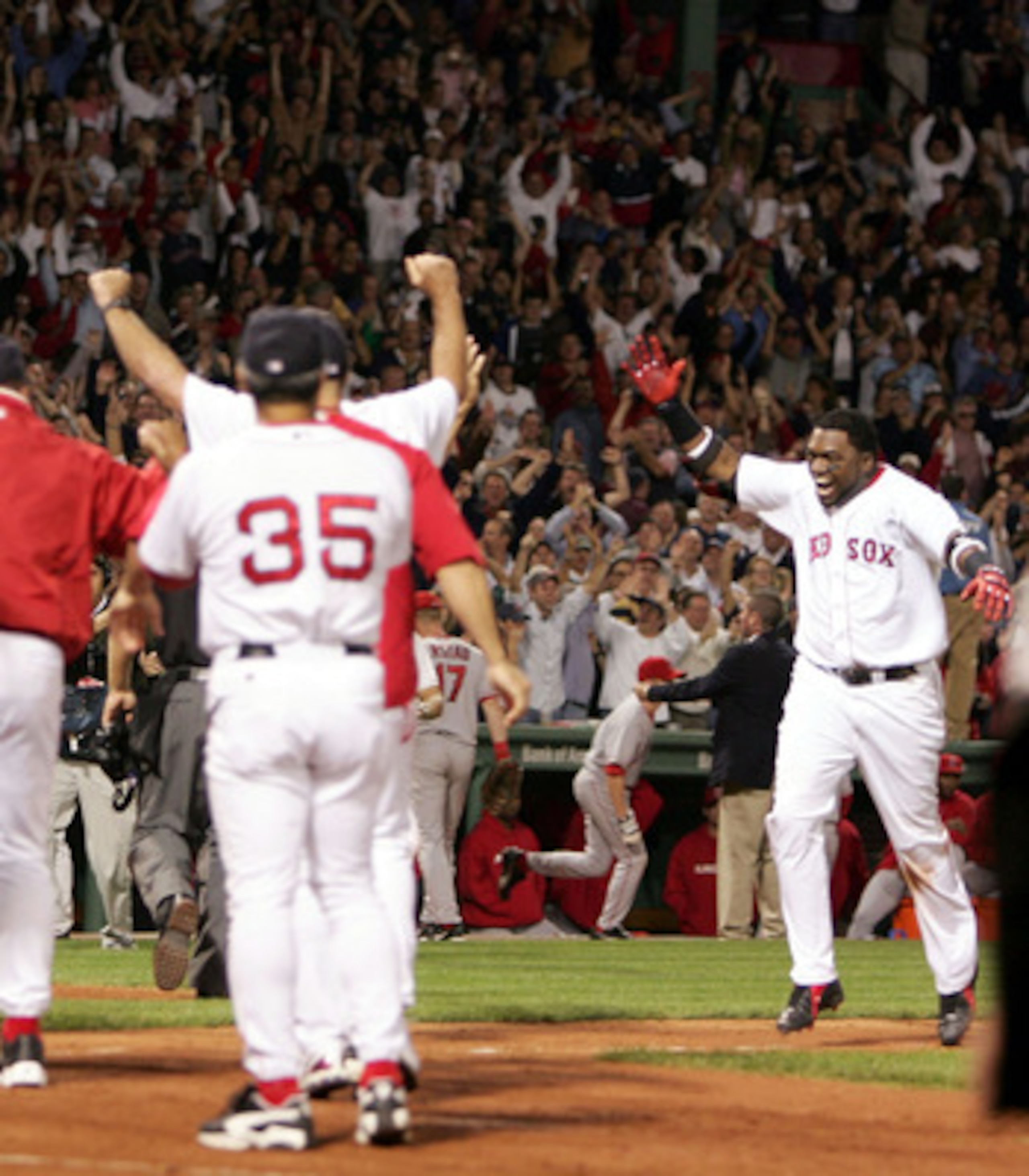BOSTON - OCTOBER 8: David Ortiz #34 of the Boston Red Sox runs to his teammates after hitting the game winning homerun to defeat the Anaheim Angels 8-6 in the 10th inning of Game 3 of the American League Division Series on October 8, 2004 at Fenway Park BOSTON - OCTOBER 8: David Ortiz #34 of the Boston Red Sox runs to his teammates after hitting the game winning homerun to defeat the Anaheim Angels 8-6 in the 10th inning of Game 3 of the American League Division Series on October 8, 2004 at Fenway Park