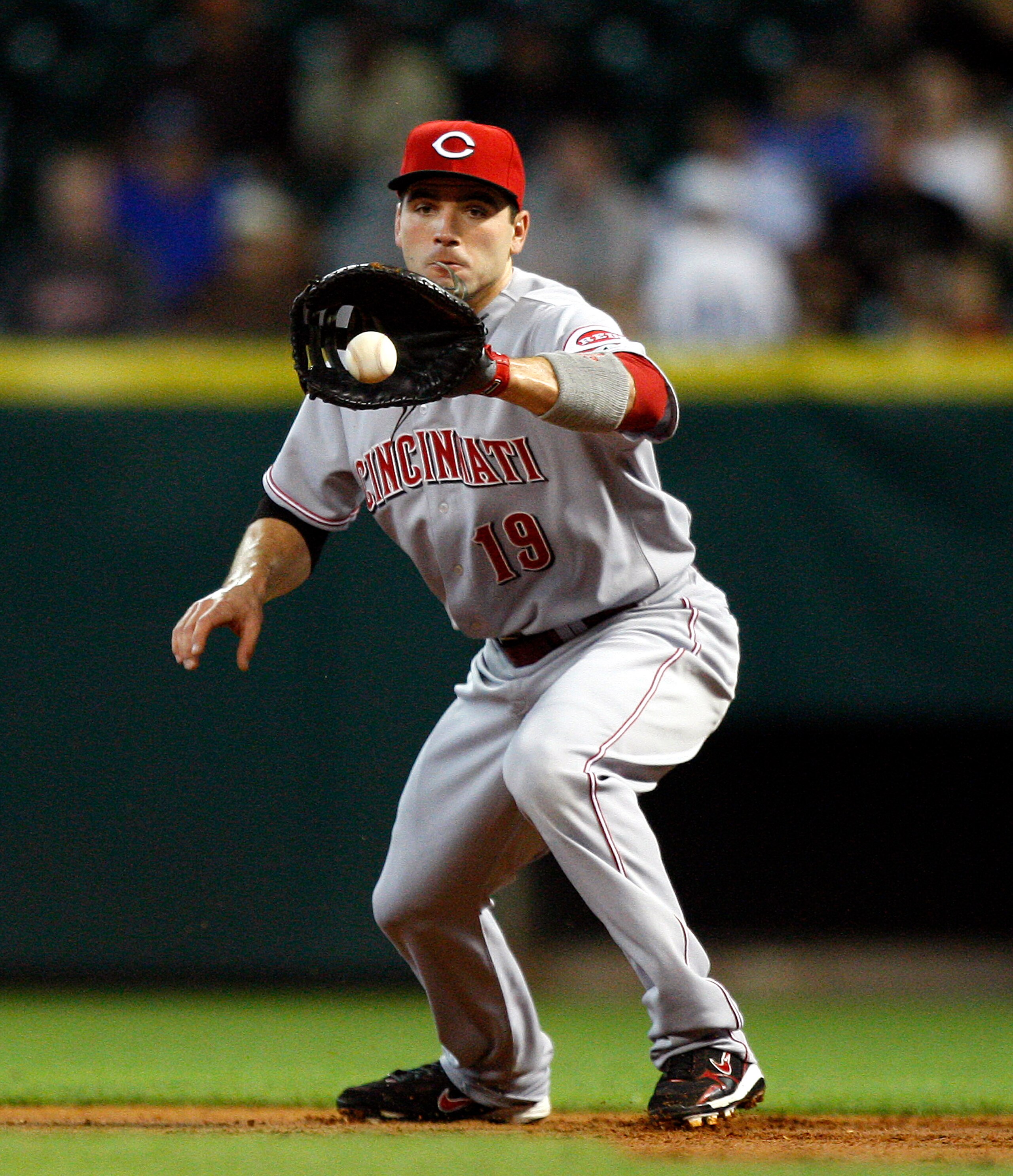 HOUSTON - MAY 11: First baseman Joey Votto #19 of the Cincinnati Reds fields a ground ball during  a baseball game against the Houston Astros at Minute Maid Park on May 11, 2011 in Houston, Texas.  (Photo by Bob Levey/Getty Images)