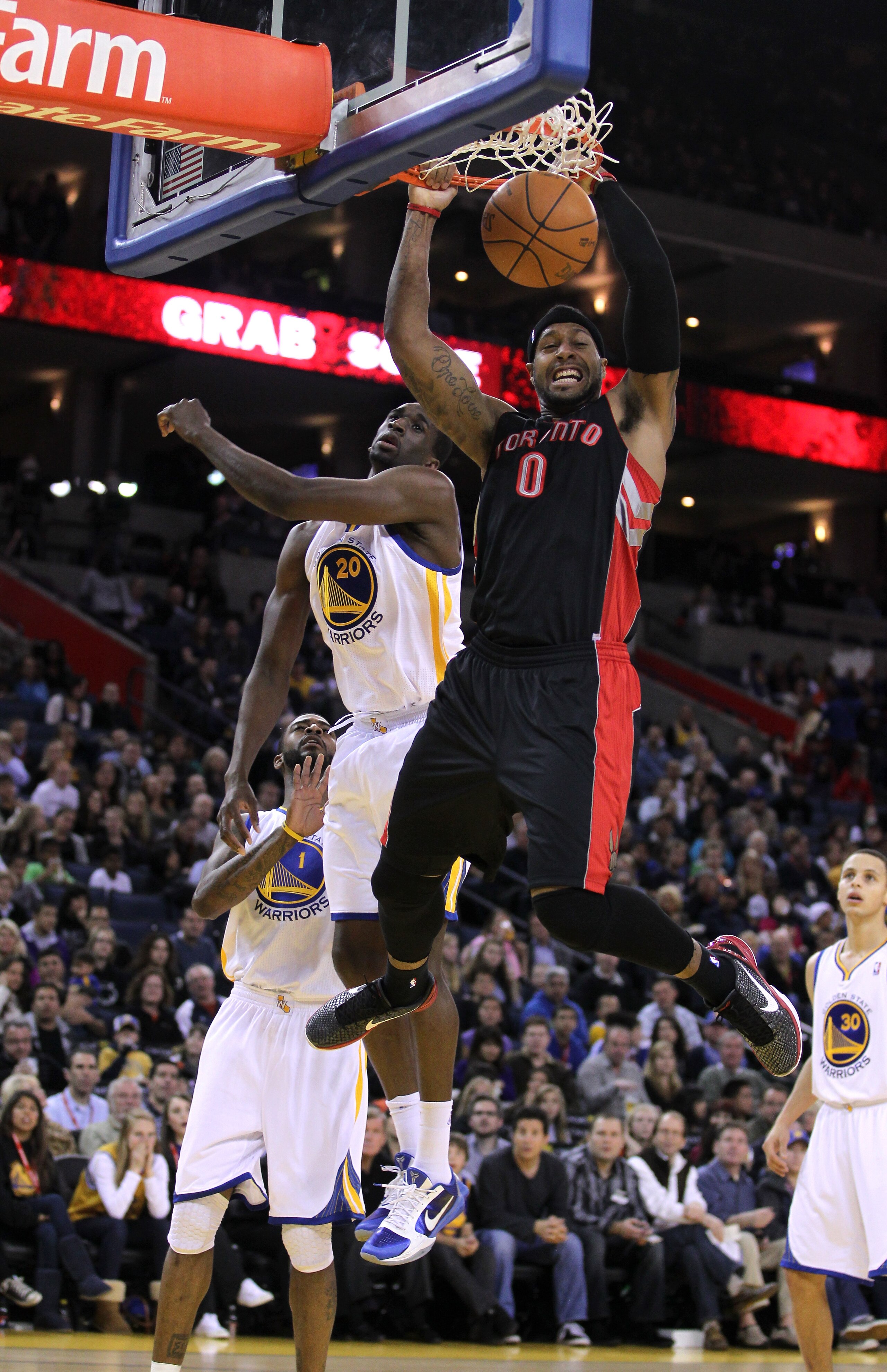 OAKLAND, CA - MARCH 25:  James Johnson #0 of the Toronto Raptors dunks in front of Ekpe Udoh #20 of the Golden State Warriors at Oracle Arena on March 25, 2011 in Oakland, California. NOTE TO USER: User expressly acknowledges and agrees that, by downloadi