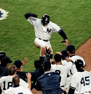 13 Oct 1999: Center fielder Bernie Williams #51 of the New York Yankees celebrates with teammates after hitting a game-winning home run against the Boston Red Sox during game 1 of the American League Championship Series at Yankee Stadium in Bronx, New Yor