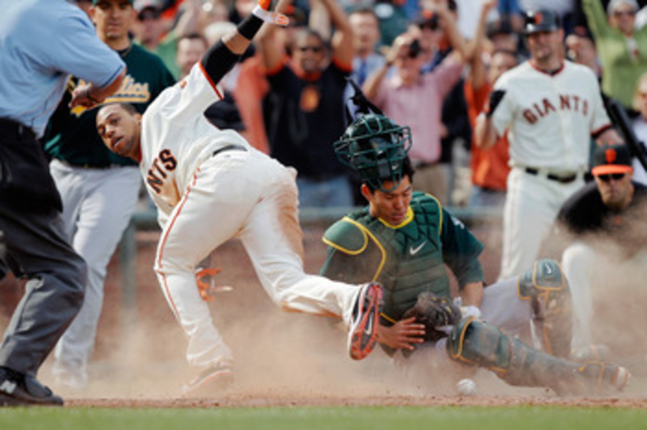 SAN FRANCISCO, CA - MAY 22: Darren Ford #34 of the San Francisco Giants scores the winning run against catcher Kurt Suzuki #8 of the Oakland A's after knocking the ball loose in the 11th inning at AT&T Park on May 22, 2011 in San Francisco, California. SAN FRANCISCO, CA - MAY 22: Darren Ford #34 of the San Francisco Giants scores the winning run against catcher Kurt Suzuki #8 of the Oakland A's after knocking the ball loose in the 11th inning at AT&T Park on May 22, 2011 in San Francisco, California.