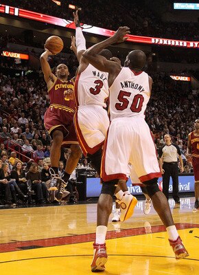 MIAMI, FL - DECEMBER 15:  Ramon Sessions #3 of the Cleveland Cavaliersshoots over Dwyane Wade #3 and  Joel Anthony #50 of the Miami Heat during a game at American Airlines Arena on December 15, 2010 in Miami, Florida. NOTE TO USER: User expressly acknowle