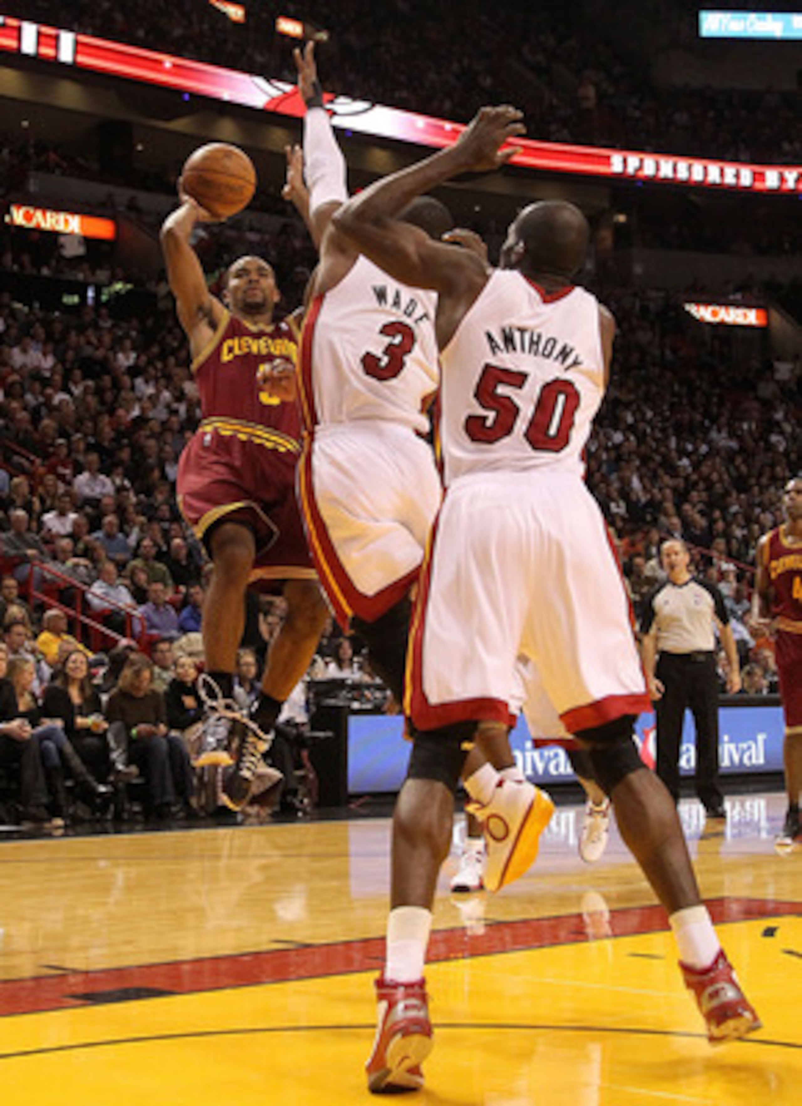 MIAMI, FL - DECEMBER 15:  Ramon Sessions #3 of the Cleveland Cavaliersshoots over Dwyane Wade #3 and  Joel Anthony #50 of the Miami Heat during a game at American Airlines Arena on December 15, 2010 in Miami, Florida. NOTE TO USER: User expressly acknowle