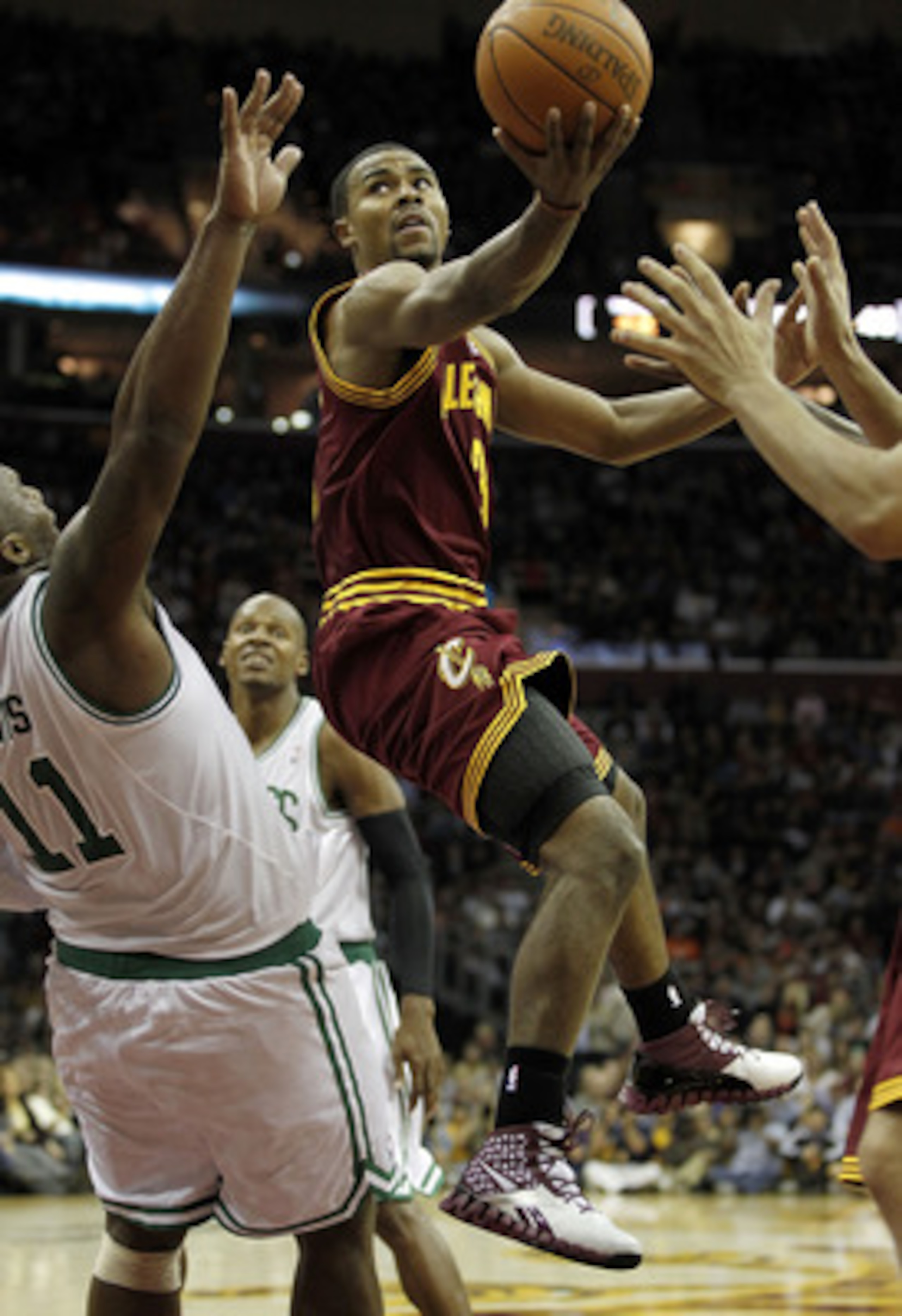 CLEVELAND - OCTOBER 27:  Ramon Sessions #3 of the Cleveland Cavaliers tries to get a shot off around Glen Davis #11 of the Boston Celtics at Quicken Loans Arena on October 27, 2010 in Cleveland, Ohio. Cleveland won the game 95-87.  (Photo by Gregory Shamu
