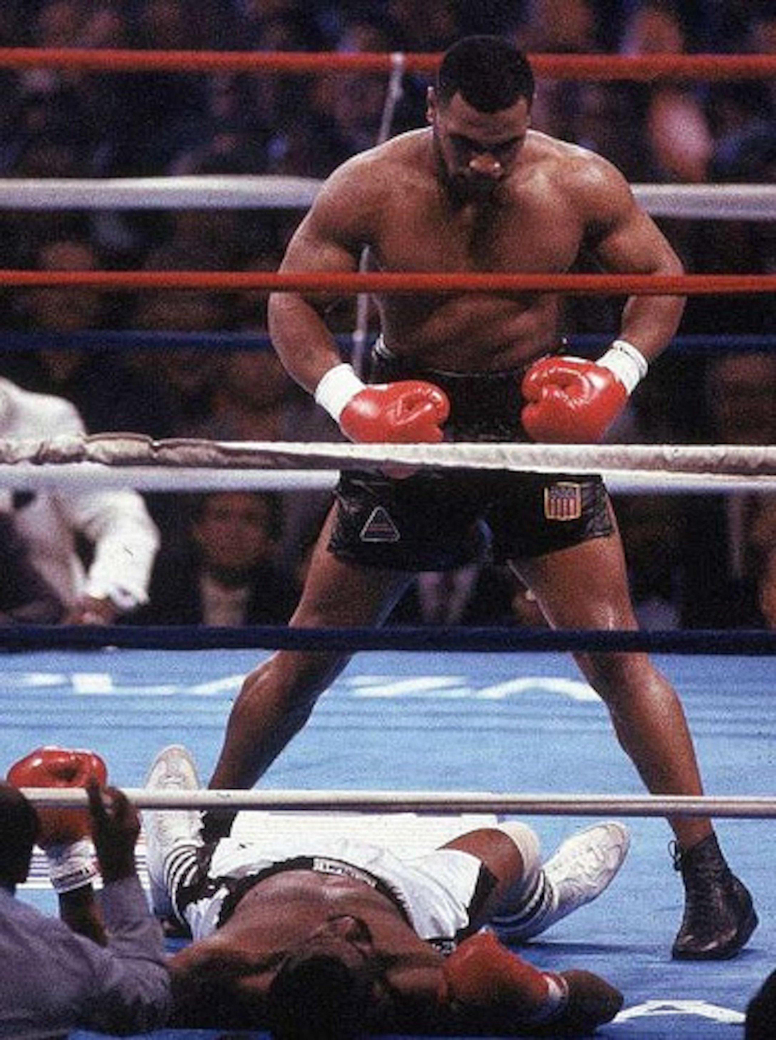 Mike Tyson stands over a crushed foe in Michael Spinks.