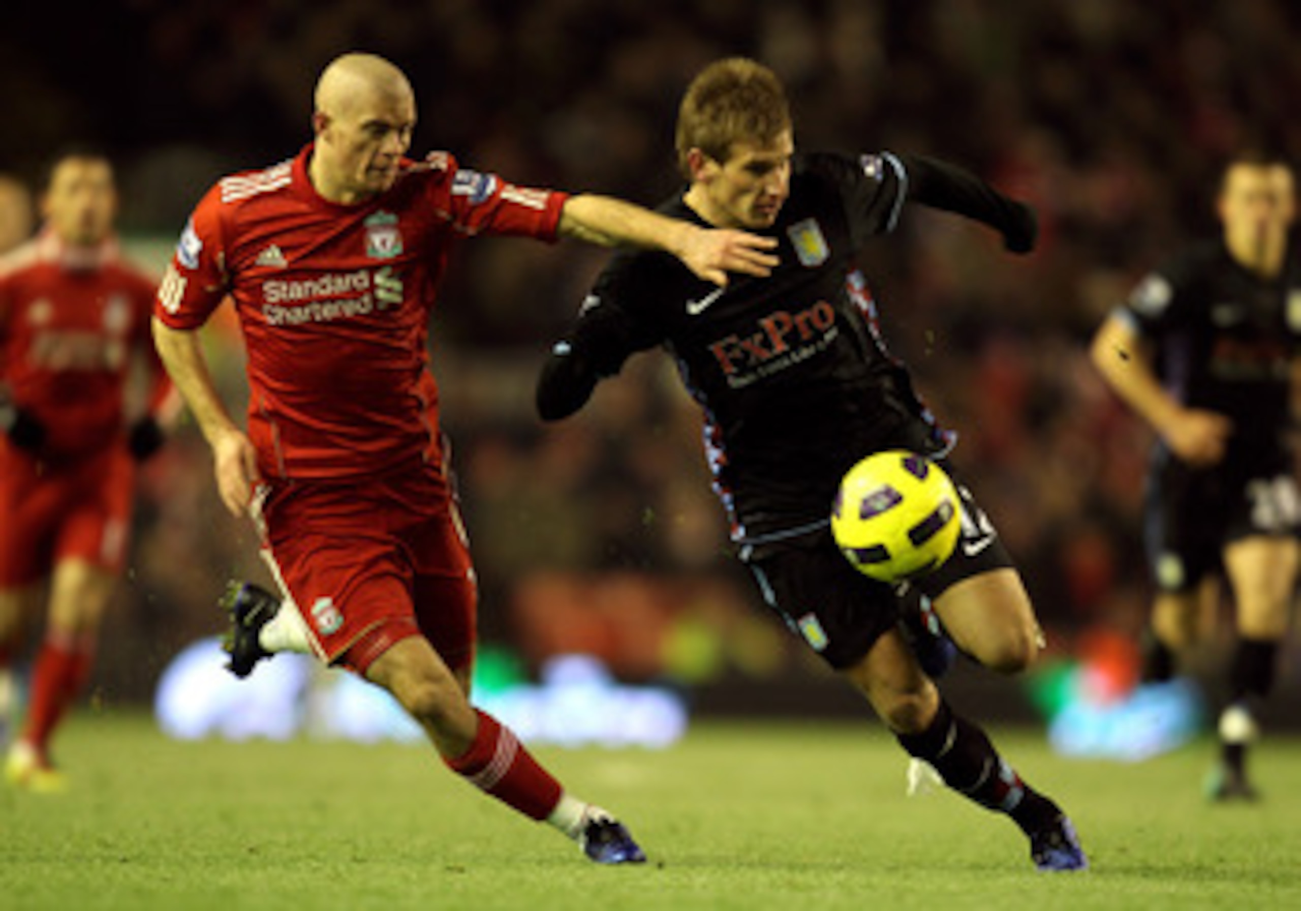 LIVERPOOL, ENGLAND - DECEMBER 06:   Marc Albrighton of Aston Villa is challenged by Paul Konchesky of Liverpool during the Barclays Premier League match between Liverpool and Aston Villa at Anfield on December 6, 2010 in Liverpool, England. (Photo by Mark