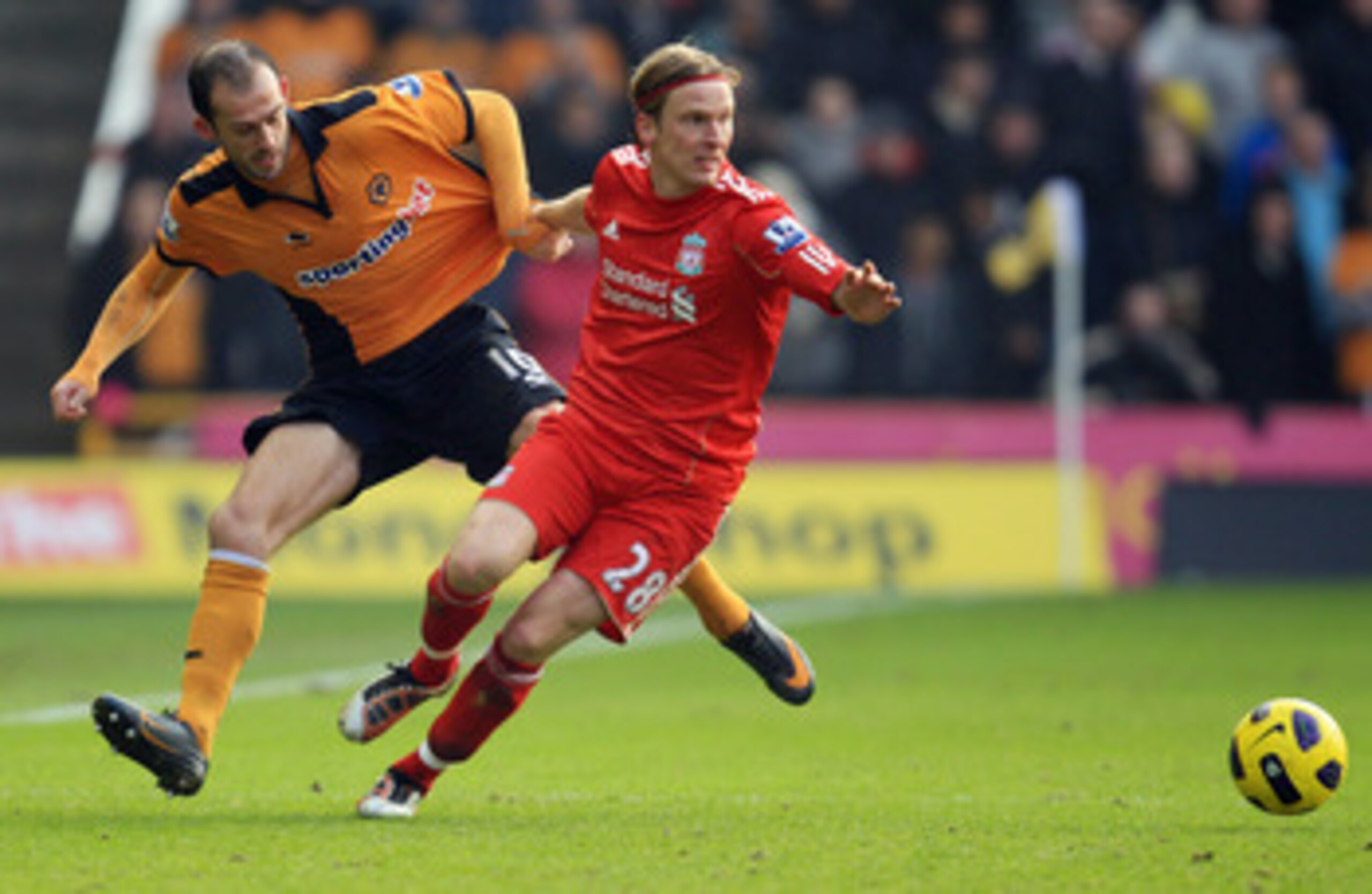 WOLVERHAMPTON, ENGLAND - JANUARY 22:  Steven Fletcher of Wolverhampton Wanderers tangles with Christian Poulsen of Liverpool during the Barclays Premier League match between Wolverhampton Wanderers and Liverpool at Molineux on January 22, 2011 in Wolverha