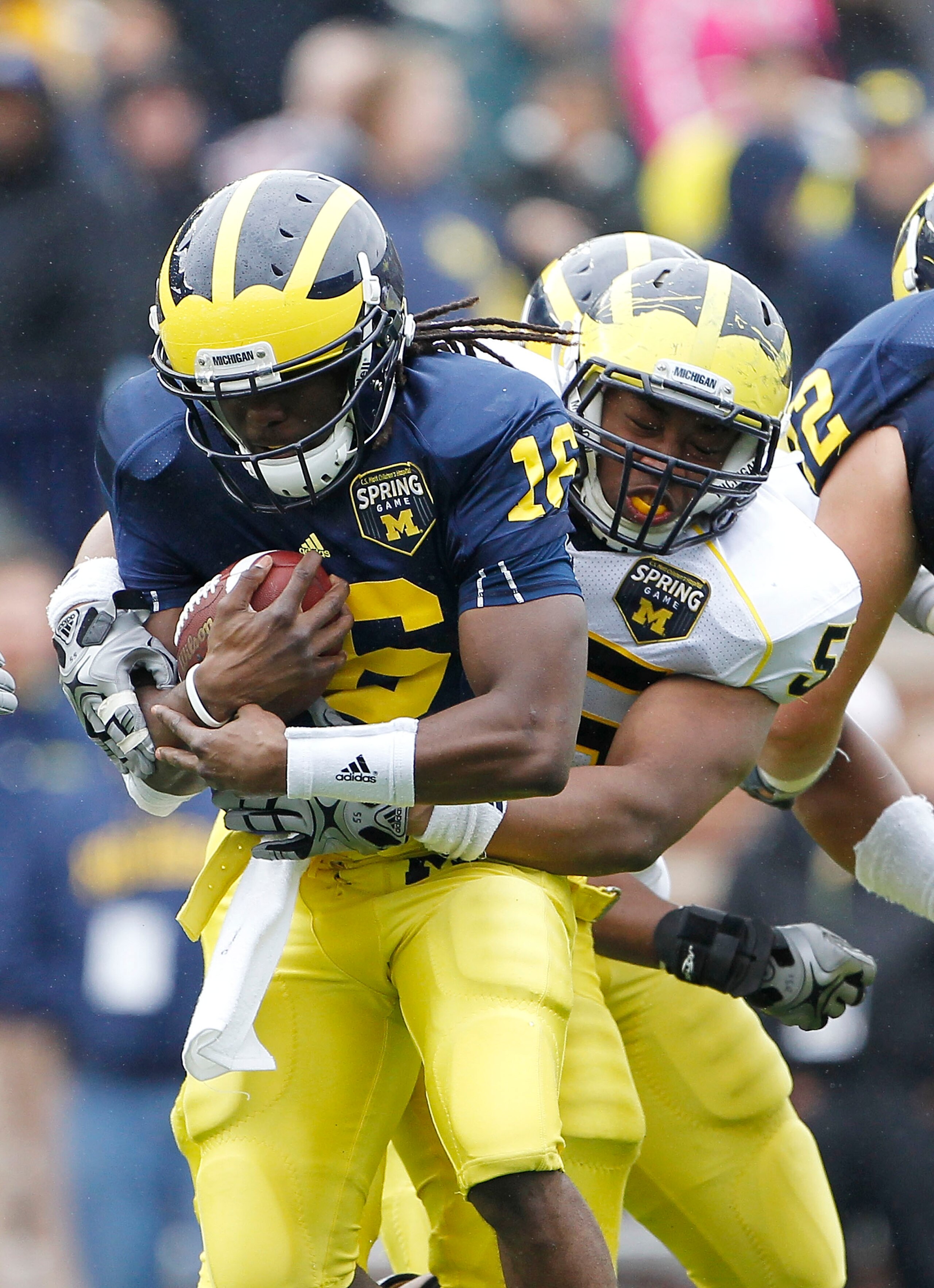 ANN ARBOR, MI - APRIL 16:  Denard Robinson #16 of the Michigan Wolverines is tacked by teammate Jibreel Black #55 during the annual Spring Game at Michigan Stadium on April 16, 2011 in Ann Arbor, Michigan.  (Photo by Leon Halip/Getty Images)