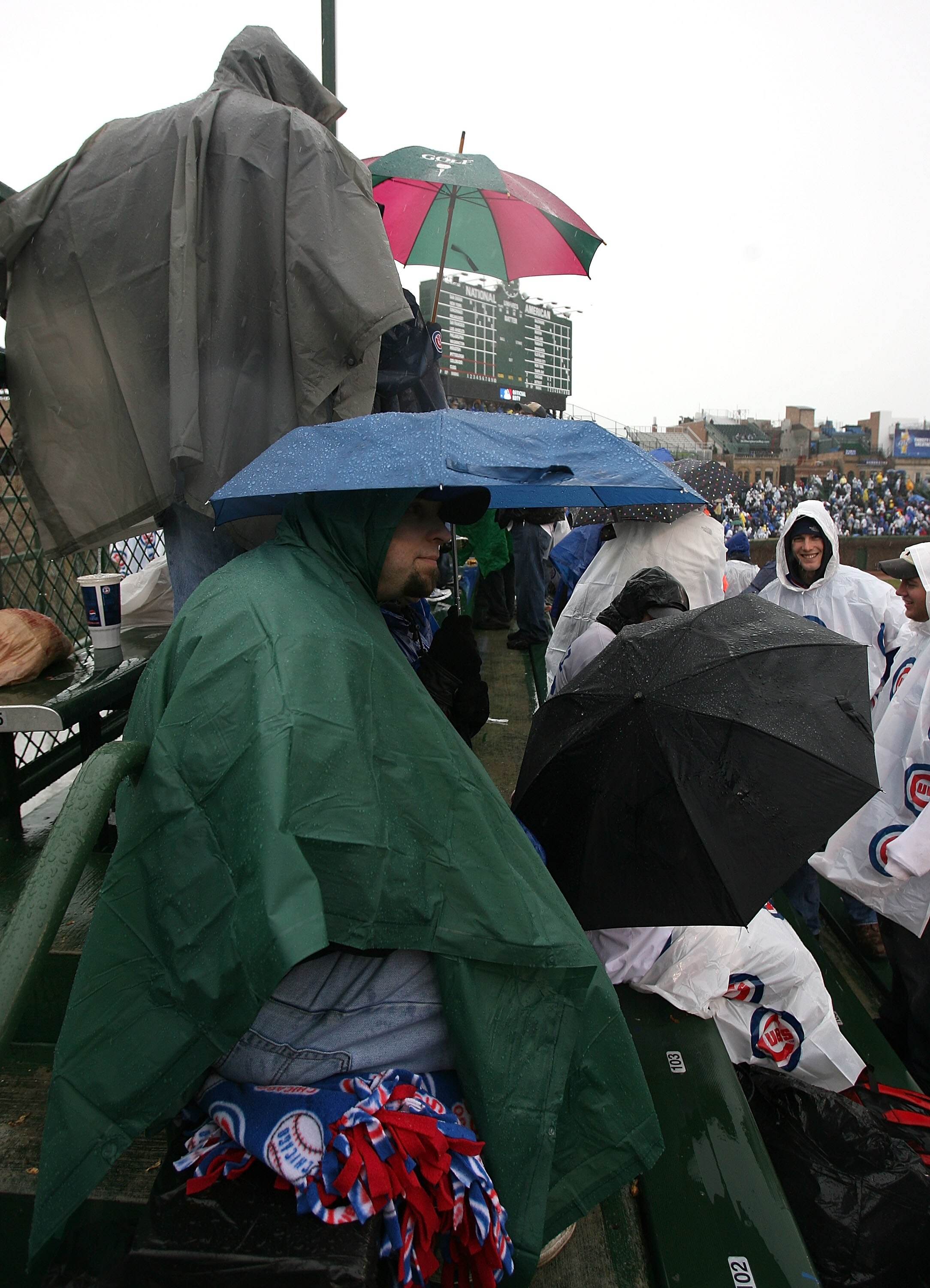 CHICAGO - APRIL 13:  Fans in the left field bleachers sit in the rain and await the start of the Opening Day game between the Chicago Cubs and the Colorado Rockies on April 13, 2009 at Wrigley Field in Chicago, Illinois.  (Photo by Jonathan Daniel/Getty I