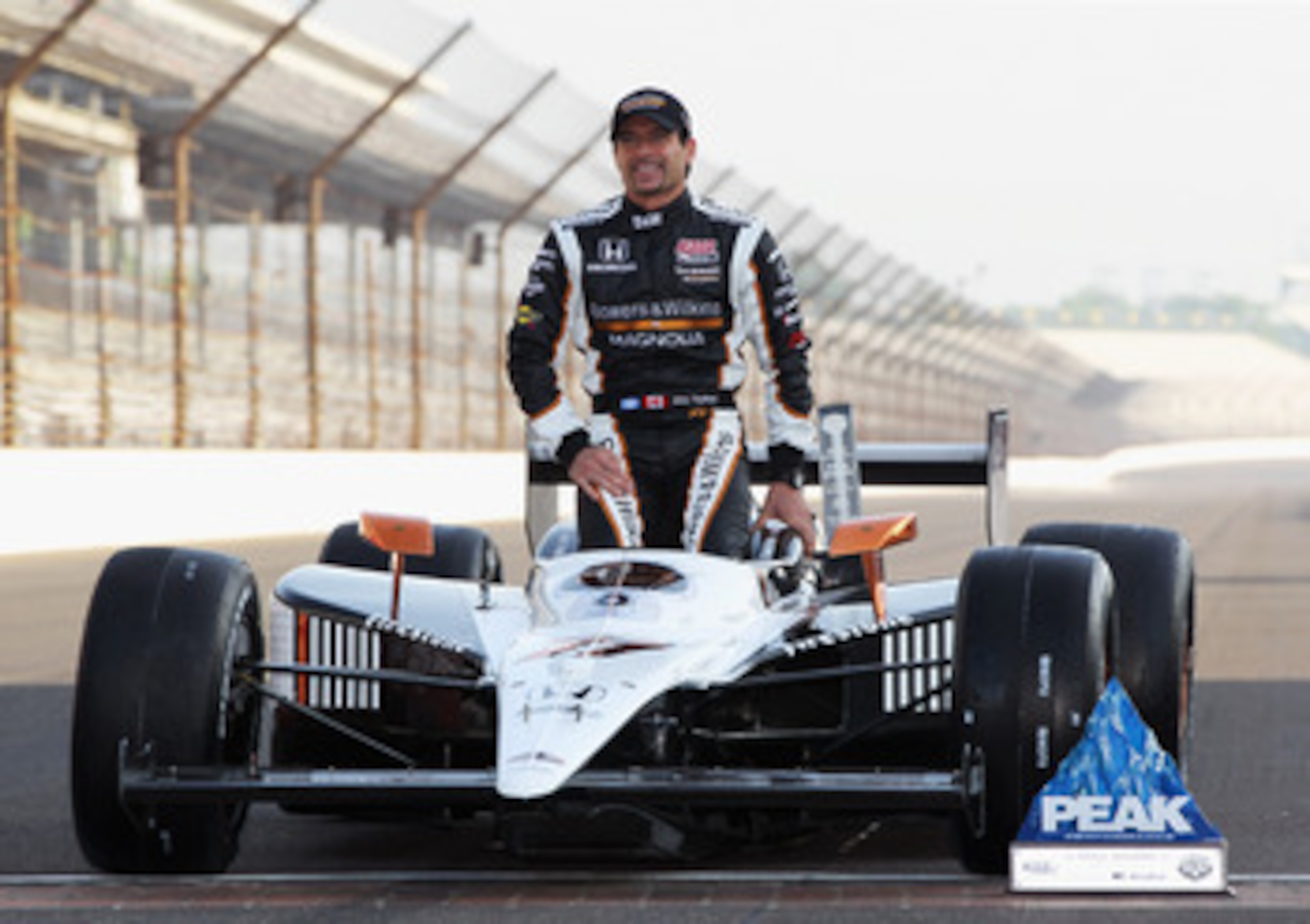 INDIANAPOLIS, IN - MAY 22:  Alex Tagliani of Canada, driver of the #77 Bowers & Wilkins/Sam Schmidt Motorsports Dallara Honda, poses on the finish line after qualifying on the pole for the Indianapolis 500 on May 22, 2011 at Indianapolis Motor Speedway in