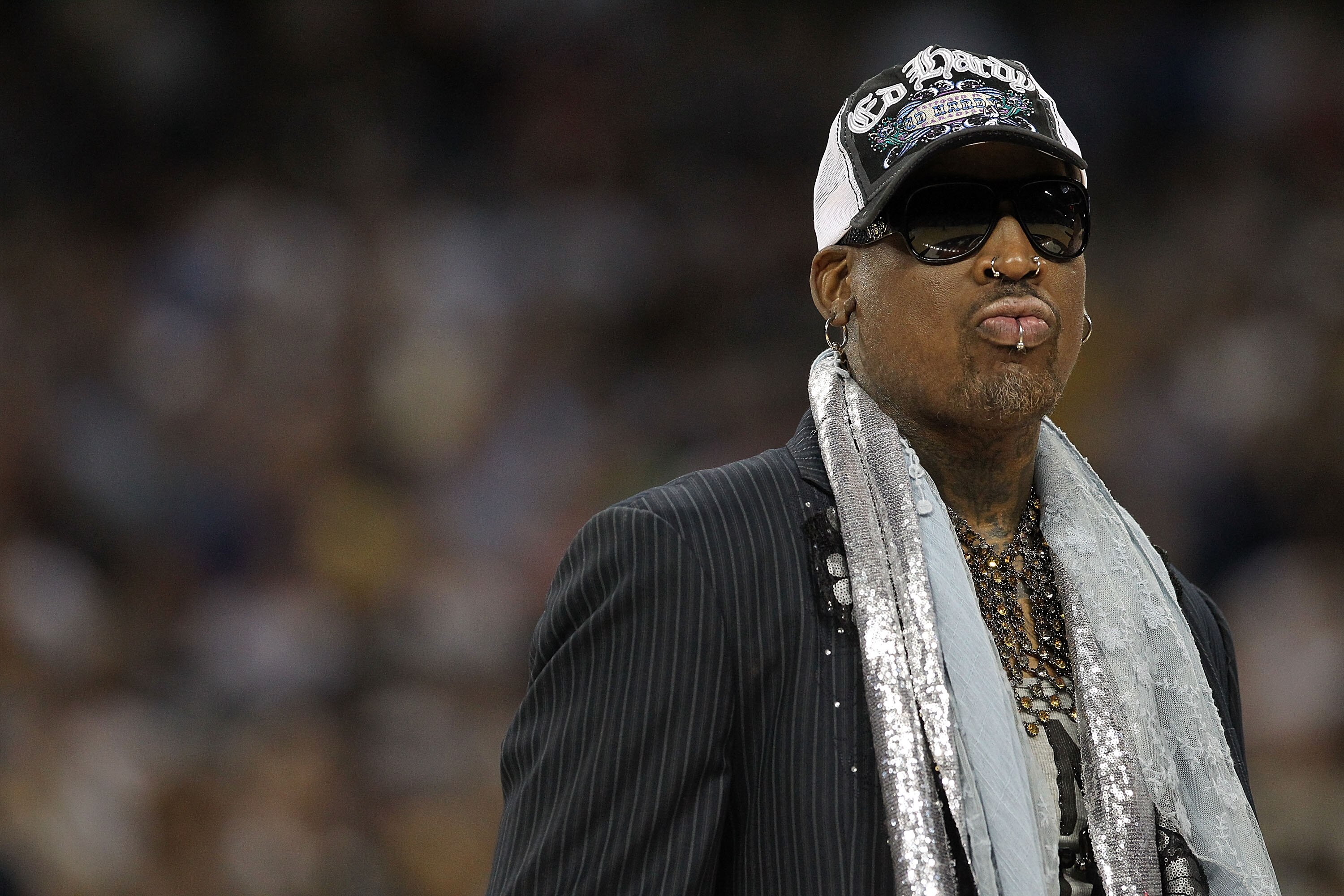 HOUSTON, TX - APRIL 04:  Naismith Memorial Basketball Hall of Fame 2011 inductee Dennis Rodman looks on during halftime of the National Championship Game of the 2011 NCAA Division I Men's Basketball Tournament at Reliant Stadium on April 4, 2011 in Housto
