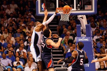 ORLANDO, FL - APRIL 26: Dwight Howard #12 of the Orlando Magic dunks over Zaza Pachulia #27 of the Atlanta Hawks during Game Five of the Eastern Conference Quarterfinals of the 2011 NBA Playoffs on April 26, 2011 at the Amway Arena in Orlando, Florida. ORLANDO, FL - APRIL 26: Dwight Howard #12 of the Orlando Magic dunks over Zaza Pachulia #27 of the Atlanta Hawks during Game Five of the Eastern Conference Quarterfinals of the 2011 NBA Playoffs on April 26, 2011 at the Amway Arena in Orlando, Florida.