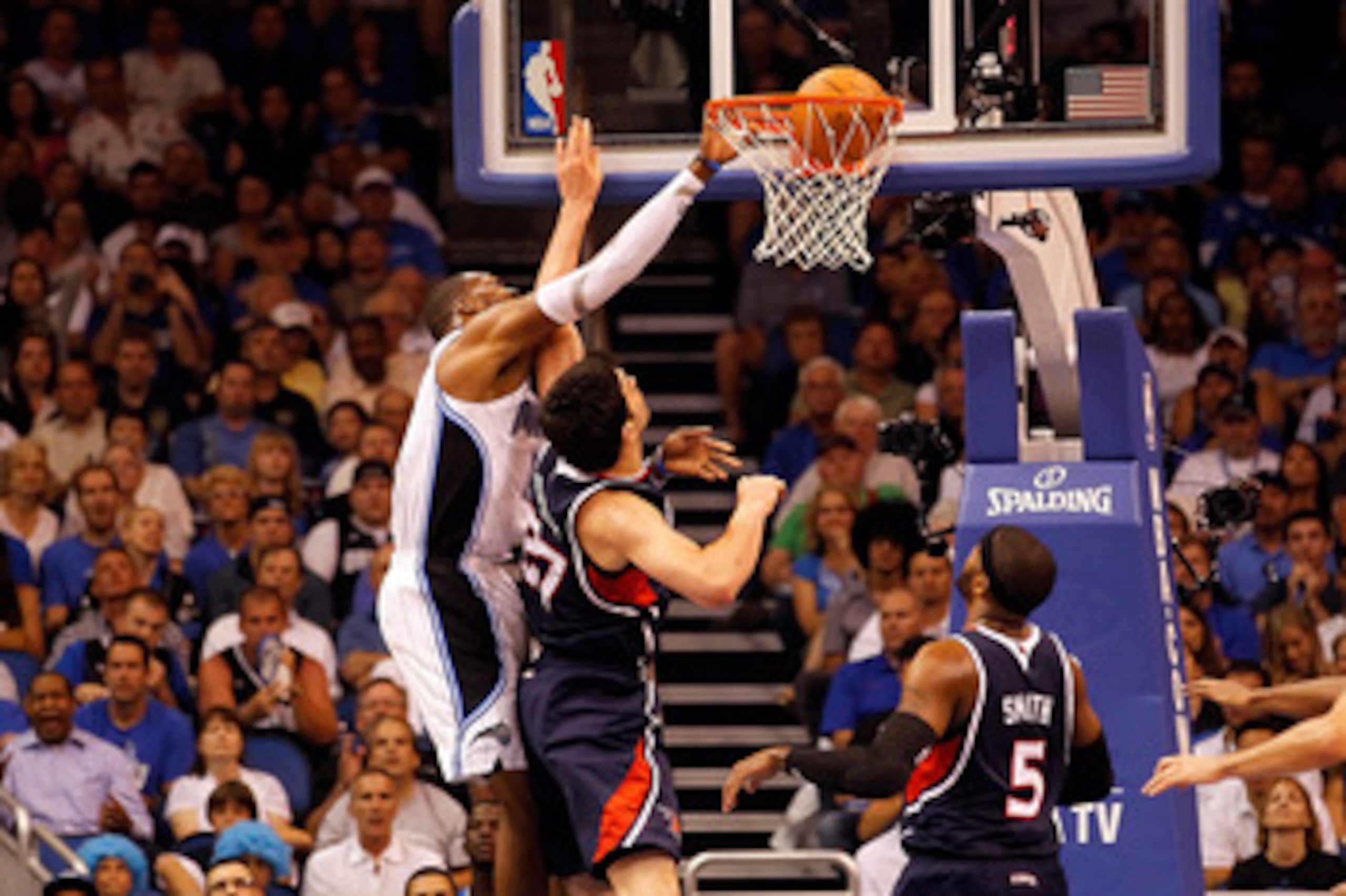 ORLANDO, FL - APRIL 26:  Dwight Howard #12 of the Orlando Magic dunks over Zaza Pachulia #27 of the Atlanta Hawks during Game Five of the Eastern Conference Quarterfinals of the 2011 NBA Playoffs on April 26, 2011 at the Amway Arena in Orlando, Florida.  