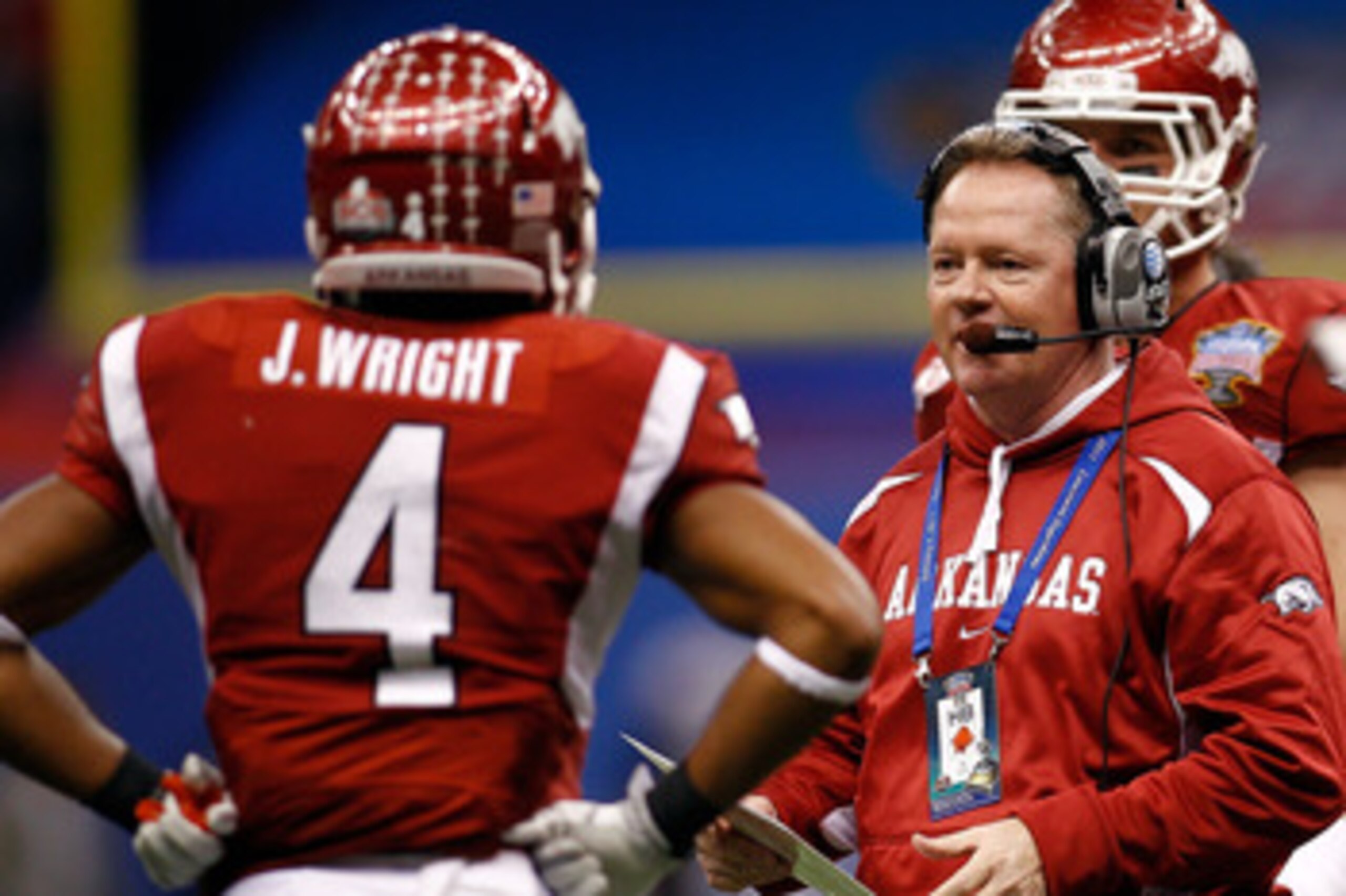 NEW ORLEANS, LA - JANUARY 04:  Head coach Bobby Petrino of the Arkansas Razorbacks looks over at Jarius Wright #4 against the Ohio State Buckeyes during the Allstate Sugar Bowl at the Louisiana Superdome on January 4, 2011 in New Orleans, Louisiana.  (Pho