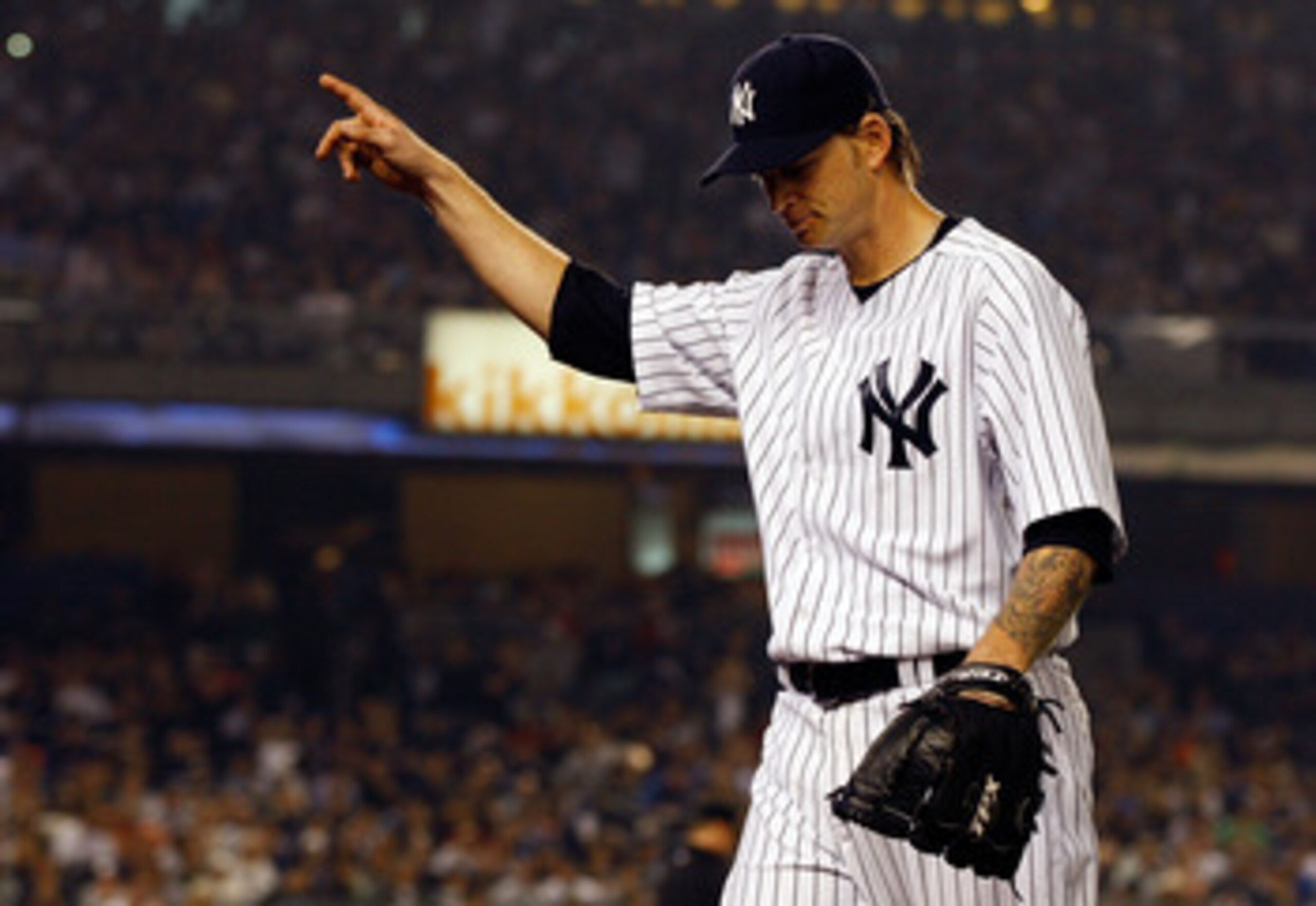 NEW YORK - MAY 21:  A.J. Burnett #34 of the New York Yankees salutes the crowd after being taken out of the game in the seventh inning against the New York Mets on May 21, 2011 at Yankee Stadium in the Bronx borough of New York City.  (Photo by Mike Stobe
