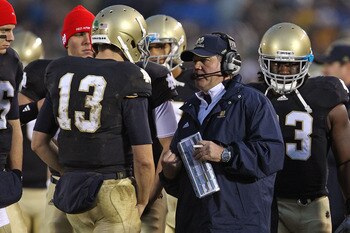 SOUTH BEND, IN - NOVEMBER 13: Head coach Brian Kelly of the Notre Dame Fighting Irish talks with Tommy Rees #13 during a game against the Utah Utes at Notre Dame Stadium on November 13, 2010 in South Bend, Indiana. Notre Dame defeated Utah 28-3. (Photo by