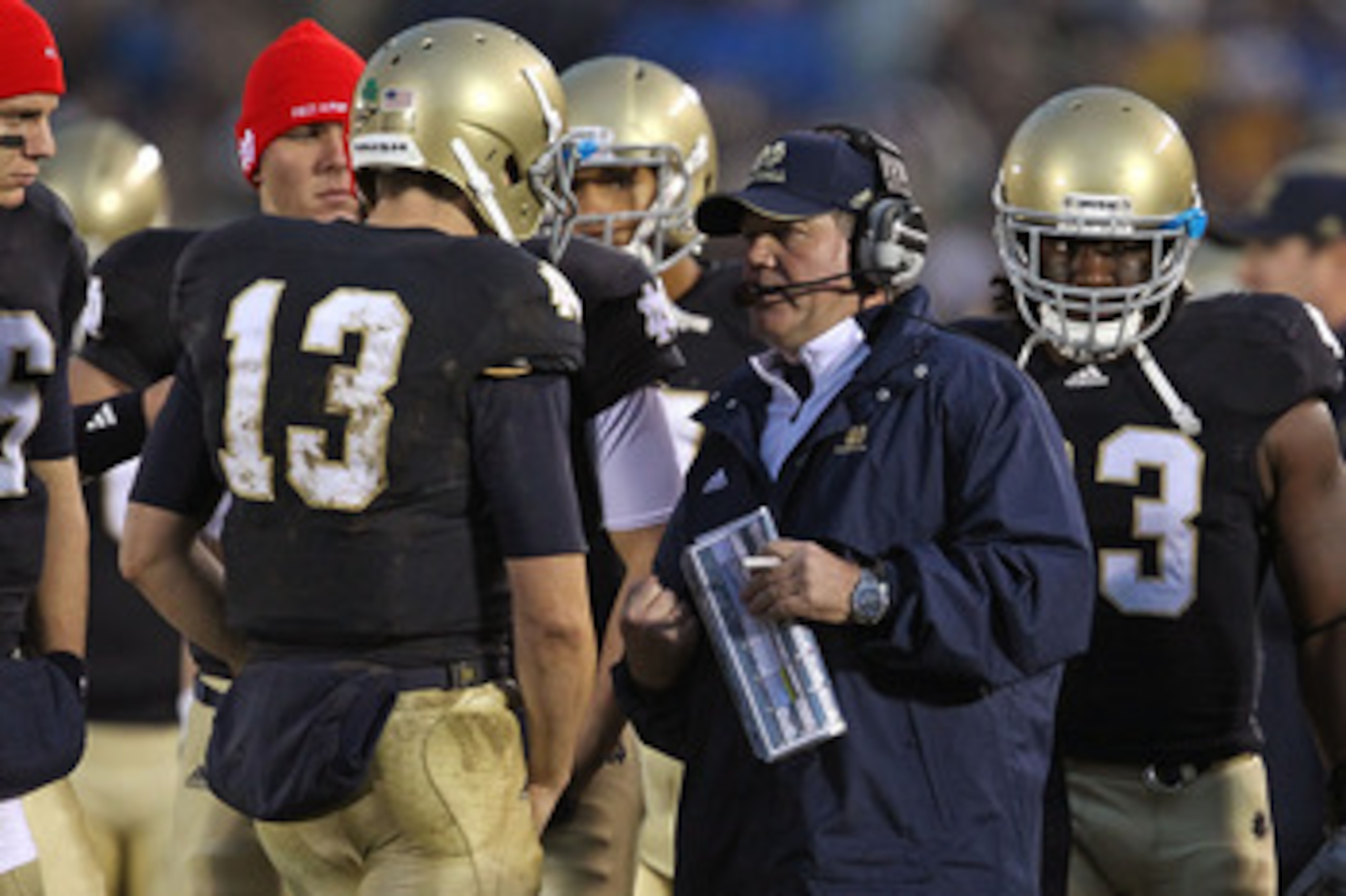SOUTH BEND, IN - NOVEMBER 13: Head coach Brian Kelly of the Notre Dame Fighting Irish talks with Tommy Rees #13 during a game against the Utah Utes at Notre Dame Stadium on November 13, 2010 in South Bend, Indiana. Notre Dame defeated Utah 28-3. (Photo by
