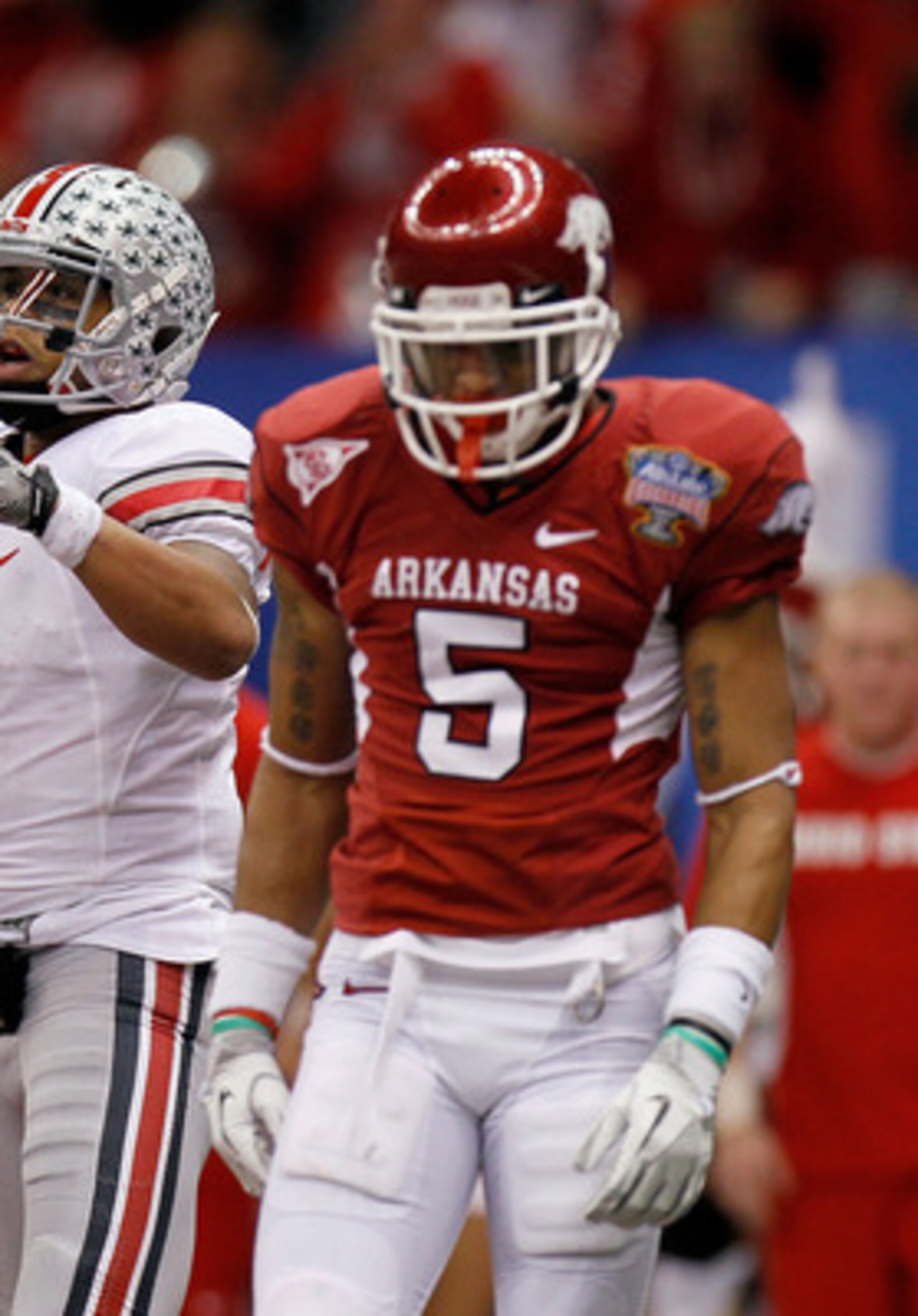 NEW ORLEANS, LA - JANUARY 04:  (L-R) Terrelle Pryor #2, Bryant Browning #70 and DeVier Posey #8 of the Ohio State Buckeyes celebrate the 43-yard touchdown catch by Posey as Tramain Thomas #5 of the Arkansas Razorbacks looks down during the Allstate Sugar