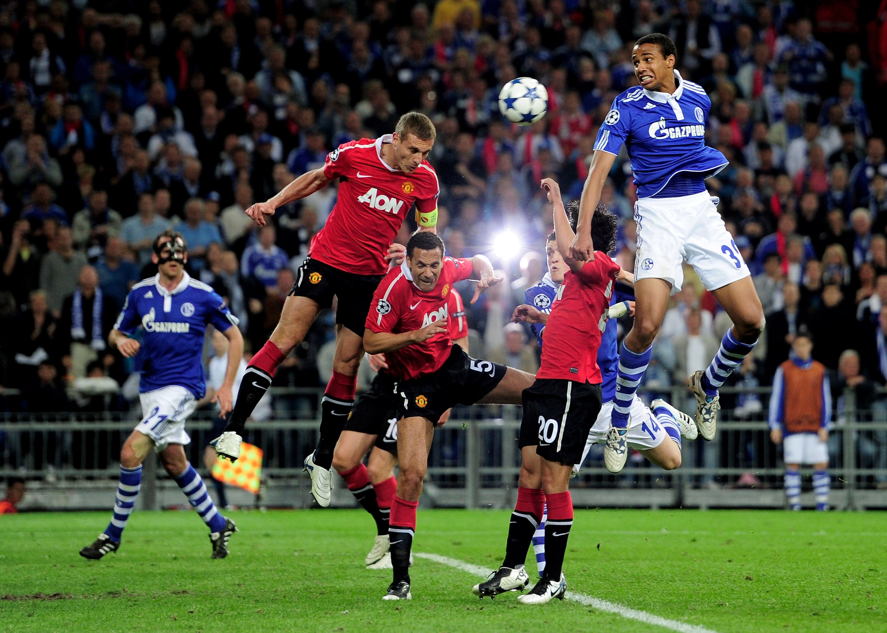 GELSENKIRCHEN, GERMANY - APRIL 26:  Nemanja Vidic of Manchester United heads clear under pressure from Joel Matip of Schalke during the UEFA Champions League Semi Final first leg match between FC Schalke 04 and Manchester United at Veltins Arena on April