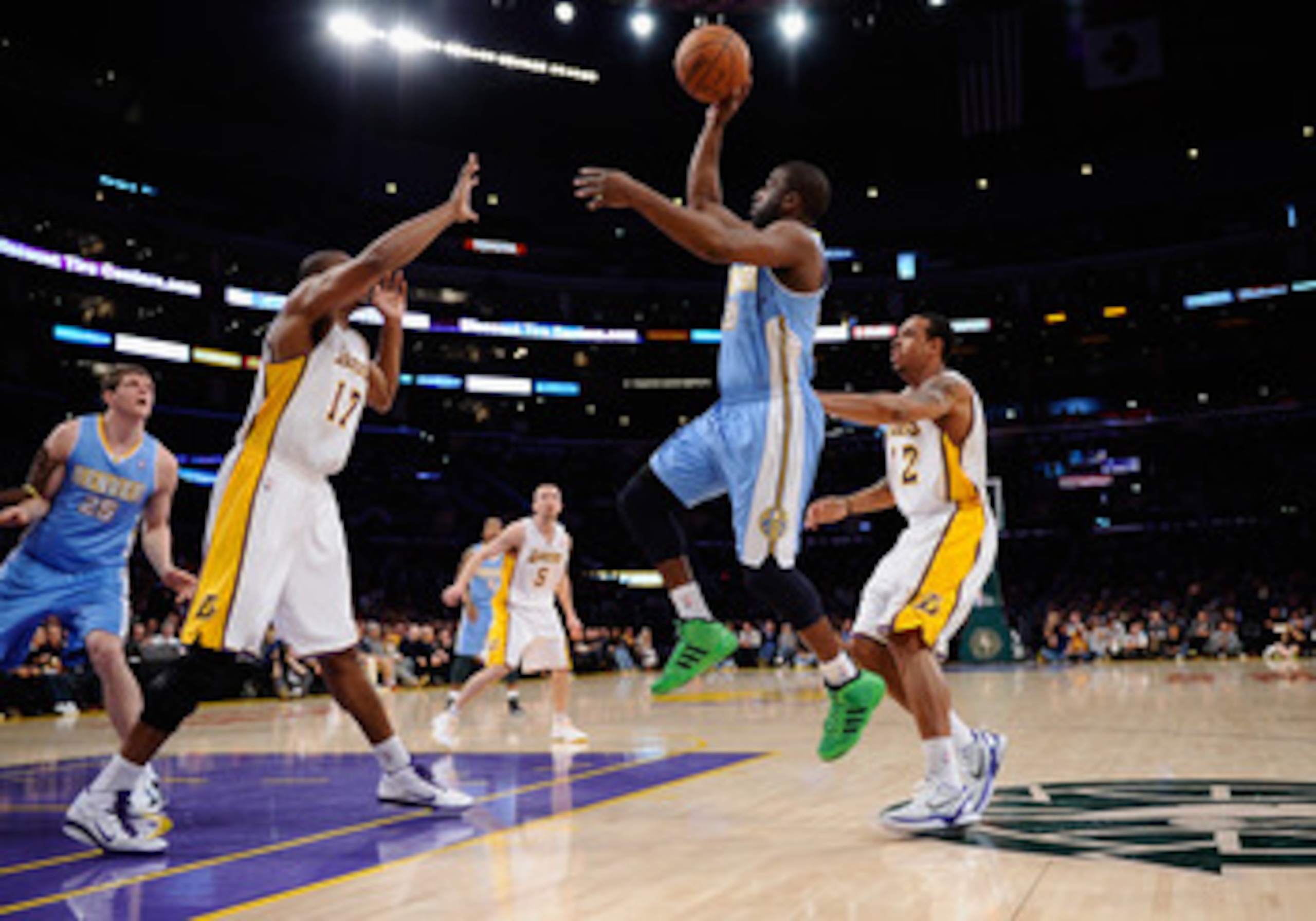 LOS ANGELES, CA - APRIL 03:  Raymond Felton #20 of the Denver Nuggets shoots over Andrew Bynum #17 and Shannon Brown #12 of the Los Angeles Lakers during the game at Staples Center on April 3, 2011 in Los Angeles, California. NOTE TO USER: User expressly 
