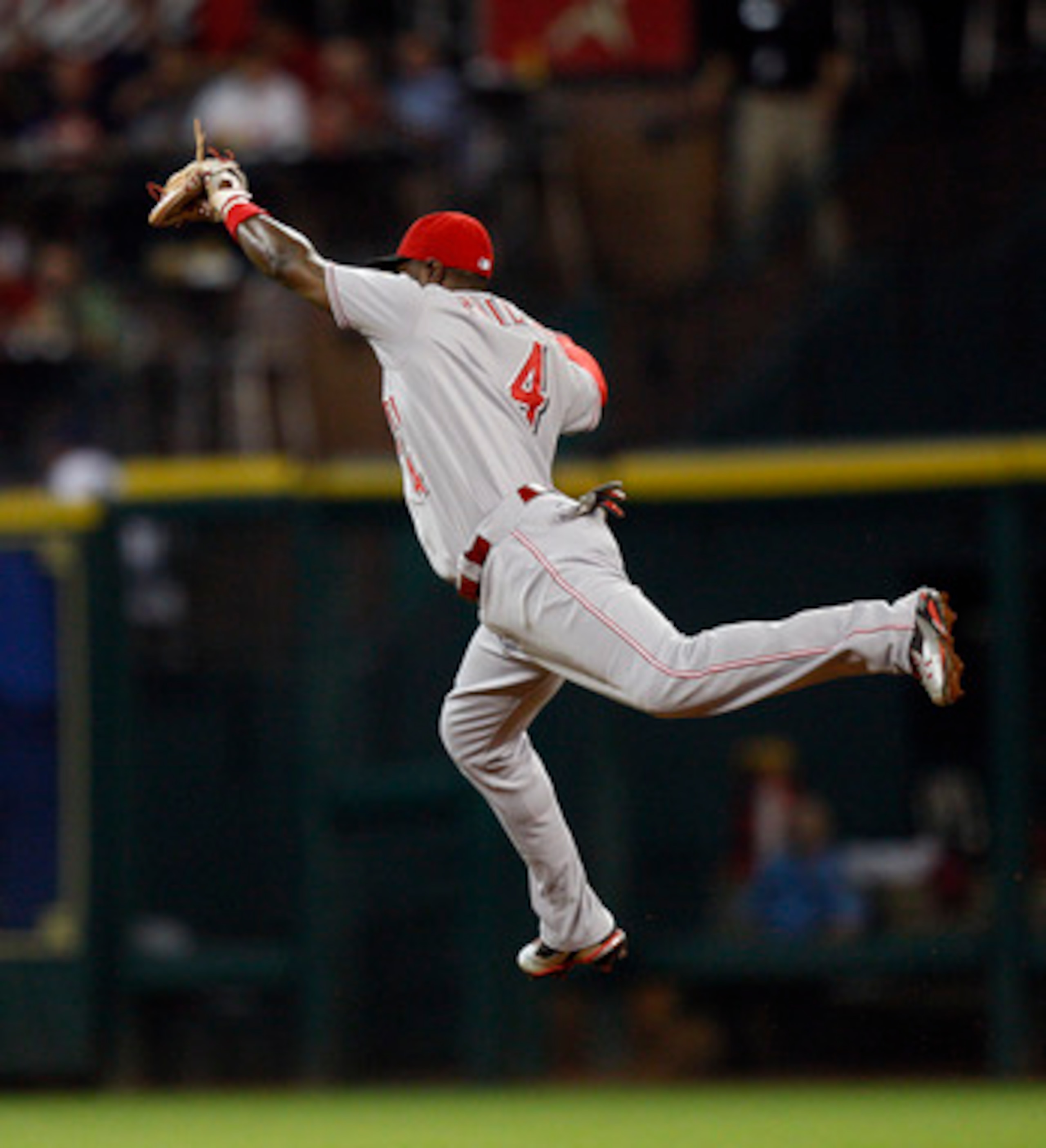 HOUSTON - MAY 11:  Second baseman Brandon Phillips #4 of the Cincinnati Reds makes a leaping catch on a ball hit by Chris Johnson #23 of the Houston Astros at Minute Maid Park on May 11, 2011 in Houston, Texas.  (Photo by Bob Levey/Getty Images)
