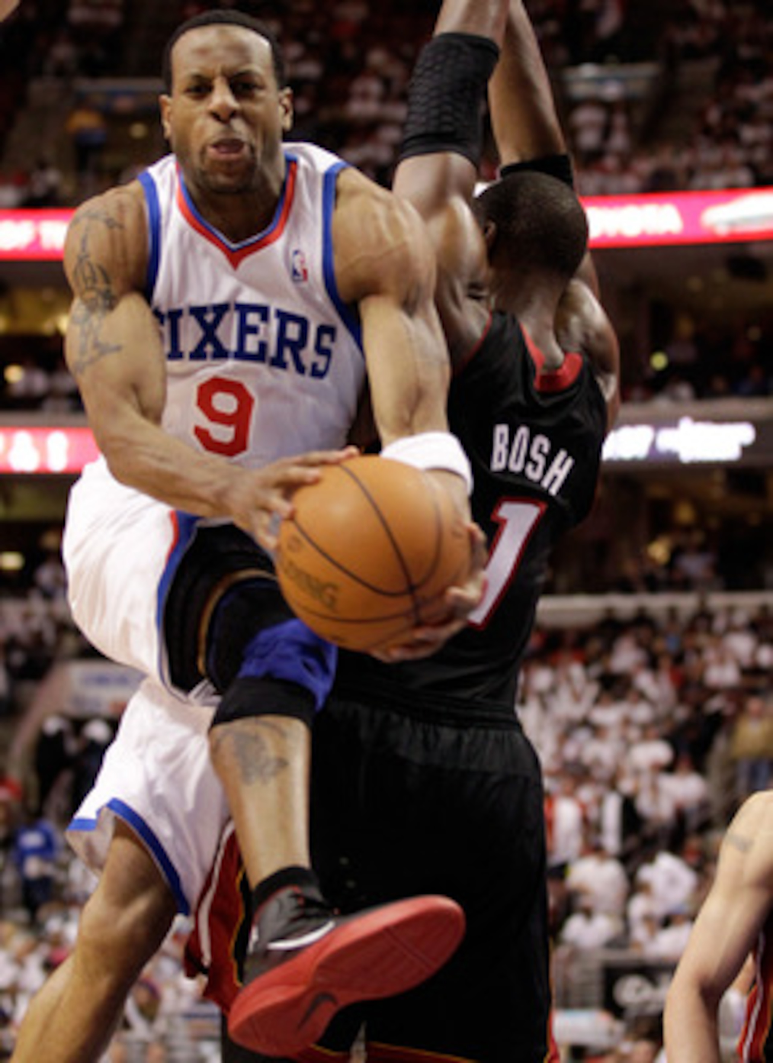 PHILADELPHIA, PA - APRIL 21: Andre Iguodala #9 of the Philadelphia 76ers drives to the basket against Chris Bosh #1 of the Miami Heat during the second half of game three of the Eastern Conference Quarterfinals at Wells Fargo Center on April 21, 2011 in P