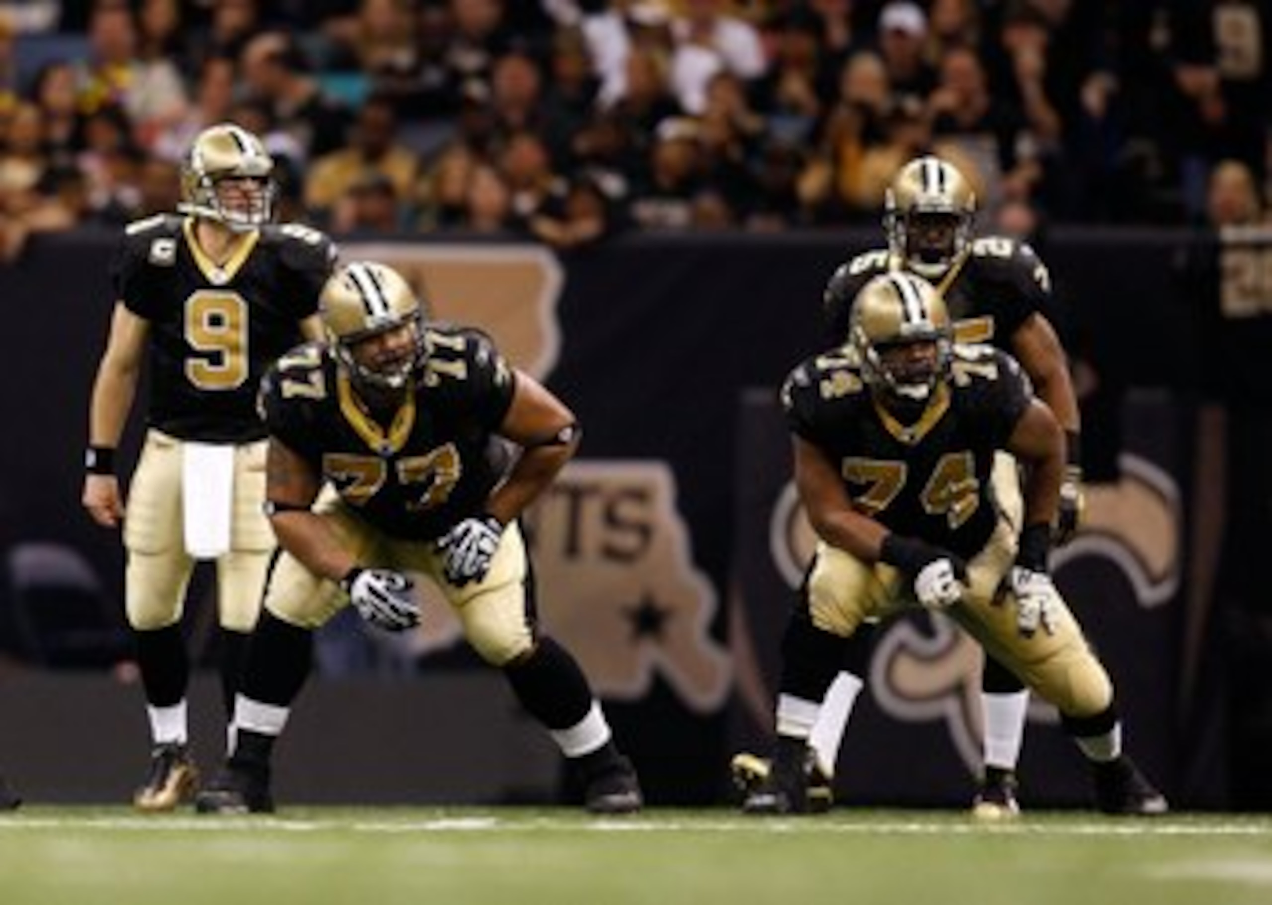 NEW ORLEANS - JANUARY 16:  (L-R) Offensive lineman Carl Nicks #77 and Jermon Bushrod #74 of the New Orleans Saints get set to pass protect as Drew Brees #9 and Reggie Bush #25 await the snap against the Arizona Cardinals during the NFC Divisional Playoff 