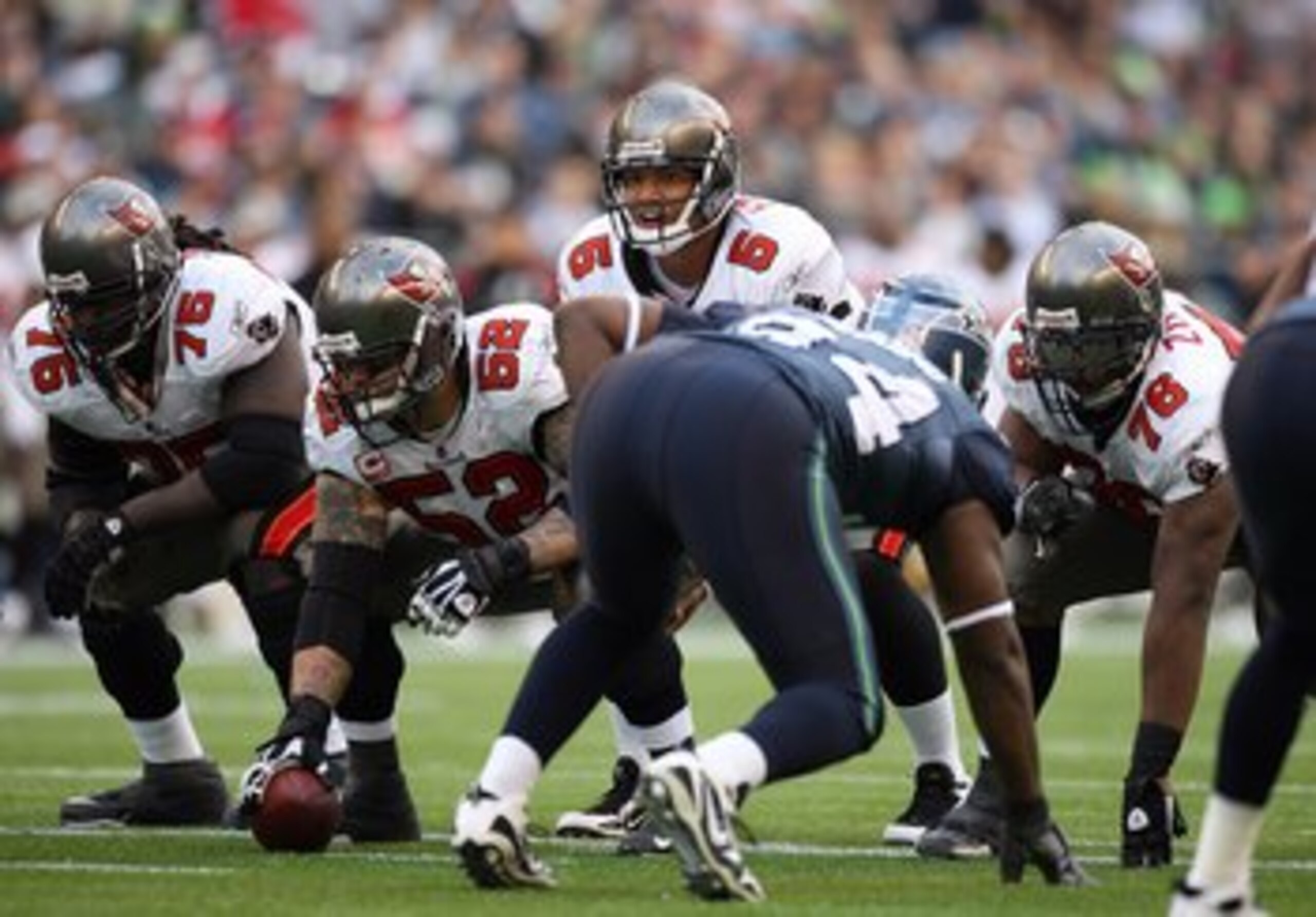 SEATTLE - DECEMBER 20:  Center Jeff Faine #52 of the Tampa Bay Buccaneers waits to snap the ball to quarterback Josh Freeman #5 during their game against the Seattle Seahawks on December 20, 2009 at Qwest Field in Seattle, Washington. The Buccaneers defea