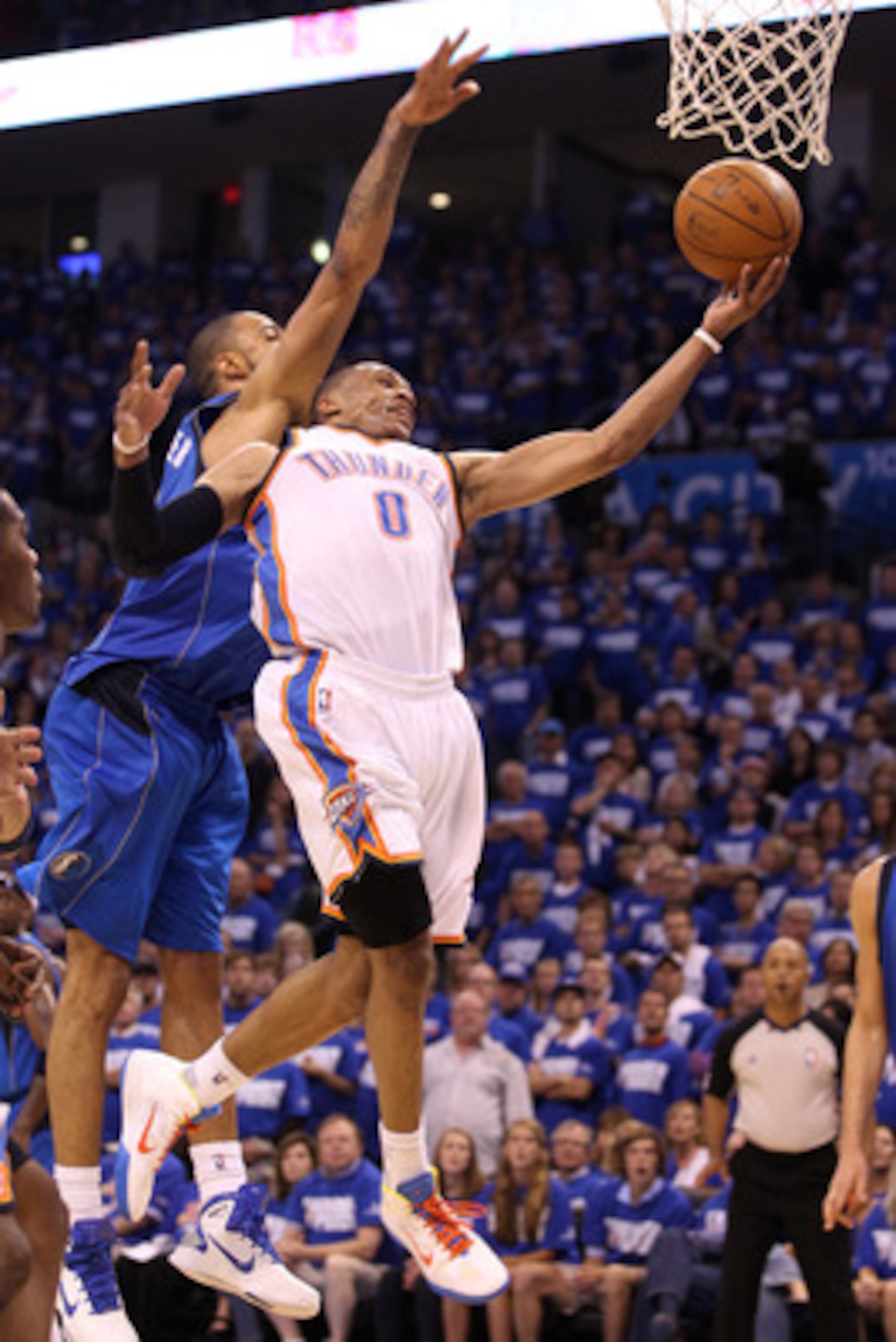 OKLAHOMA CITY, OK - MAY 21:  Russell Westbrook #0 of the Oklahoma City Thunder goes up for a shot against Tyson Chandler #6 of the Dallas Mavericks in the fourth quarter in Game Three of the Western Conference Finals during the 2011 NBA Playoffs at Oklaho