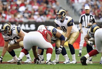 GLENDALE, AZ - DECEMBER 05:  Quarterback Sam Bradford #8 of the St. Louis Rams prepares to snap the ball during the NFL game against the Arizona Cardinals at the University of Phoenix Stadium on December 5, 2010 in Glendale, Arizona.  The Rams defeated th