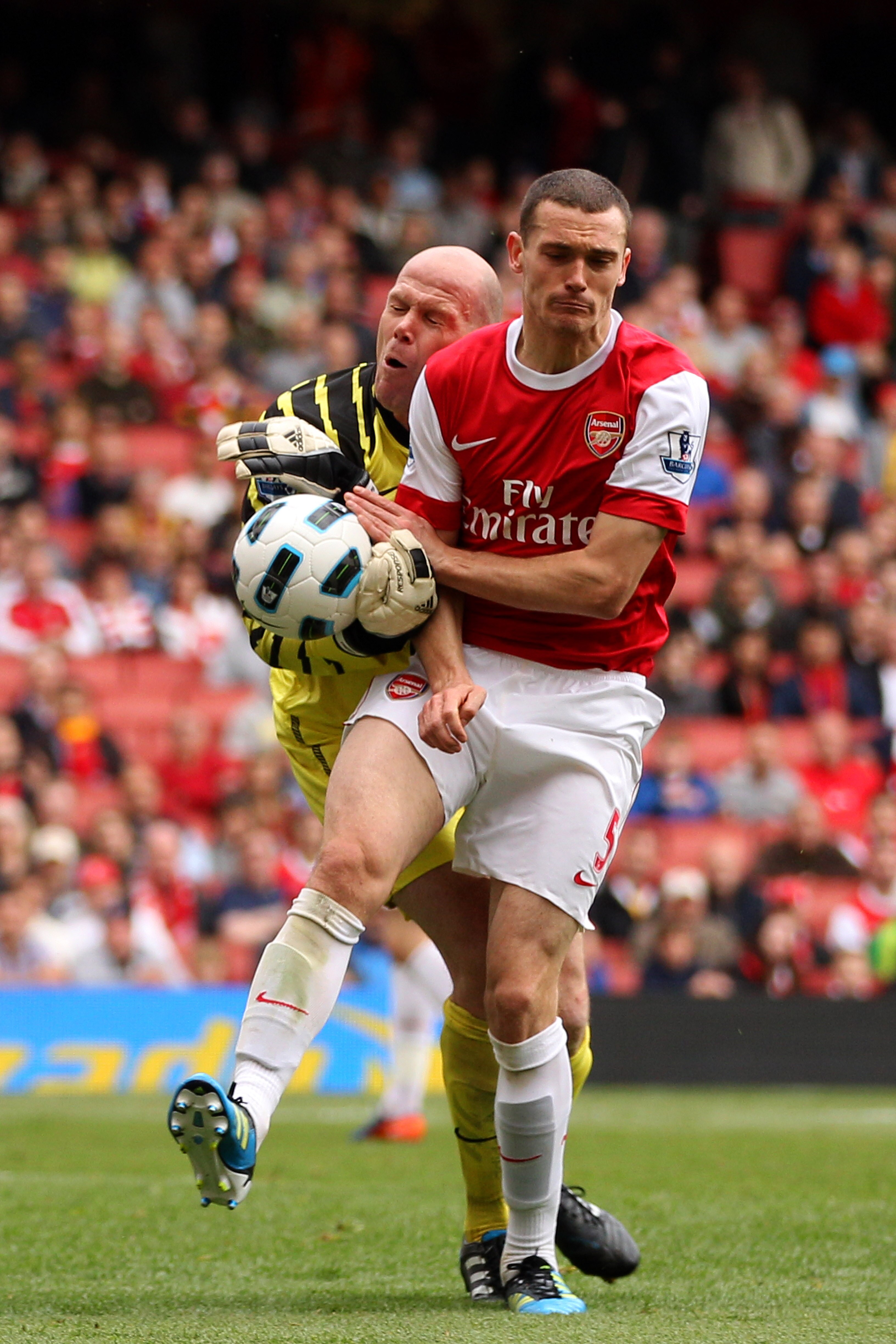 LONDON, ENGLAND - MAY 15:  Thomas Vermaelen (R) of Arsenal collides with Brad Friedel of Aston Villa during the Barclays Premier League match between Arsenal and Aston Villa at the Emirates Stadium on May 15, 2011 in London, England.  (Photo by Richard He