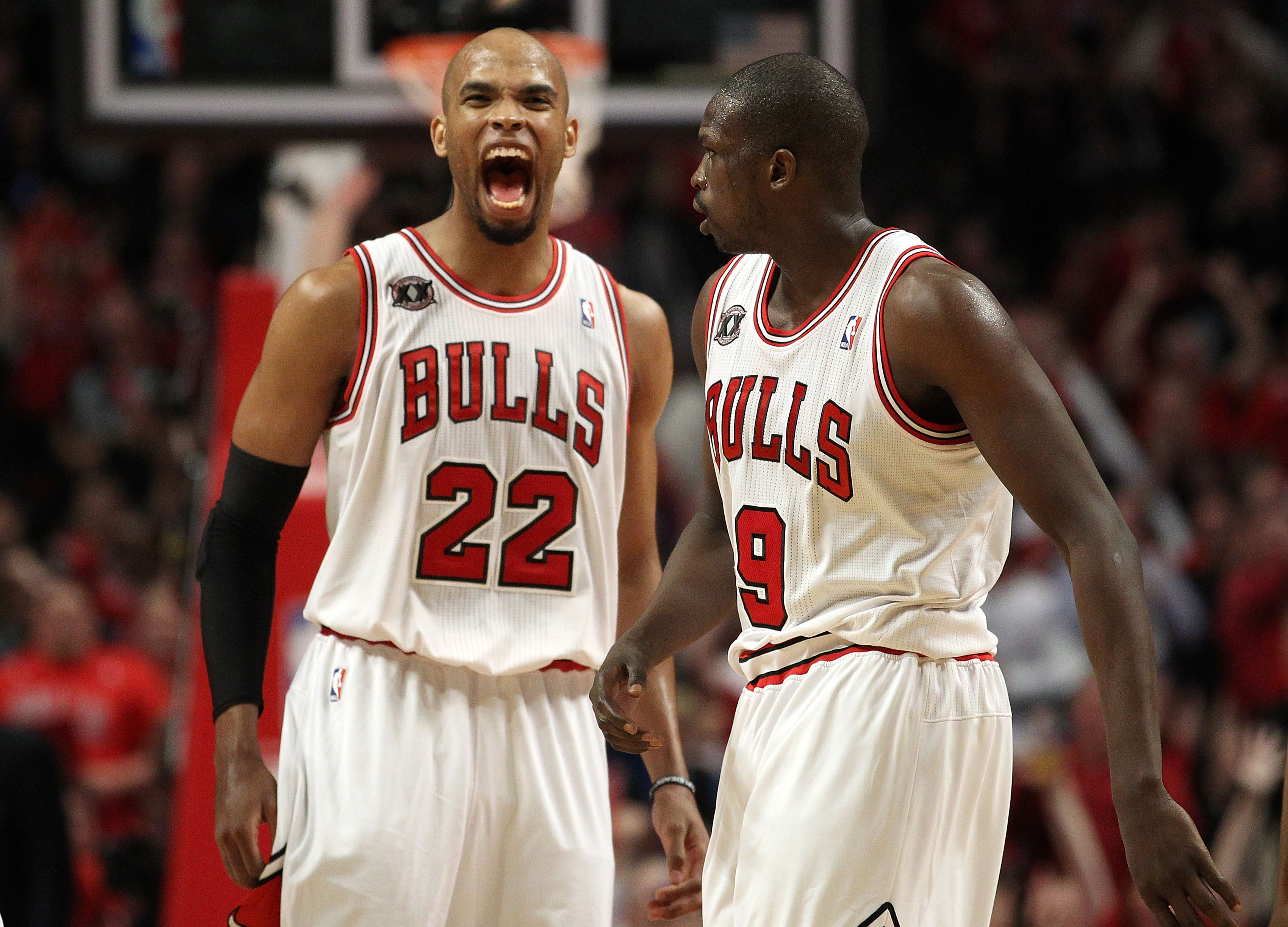 CHICAGO, IL - MAY 15:  (L-R) Taj Gibson #22 and Luol Deng #9 of the Chicago Bulls celebrate a play against the Miami Heat in Game One of the Eastern Conference Finals during the 2011 NBA Playoffs on May 15, 2011 at the United Center in Chicago, Illinois.