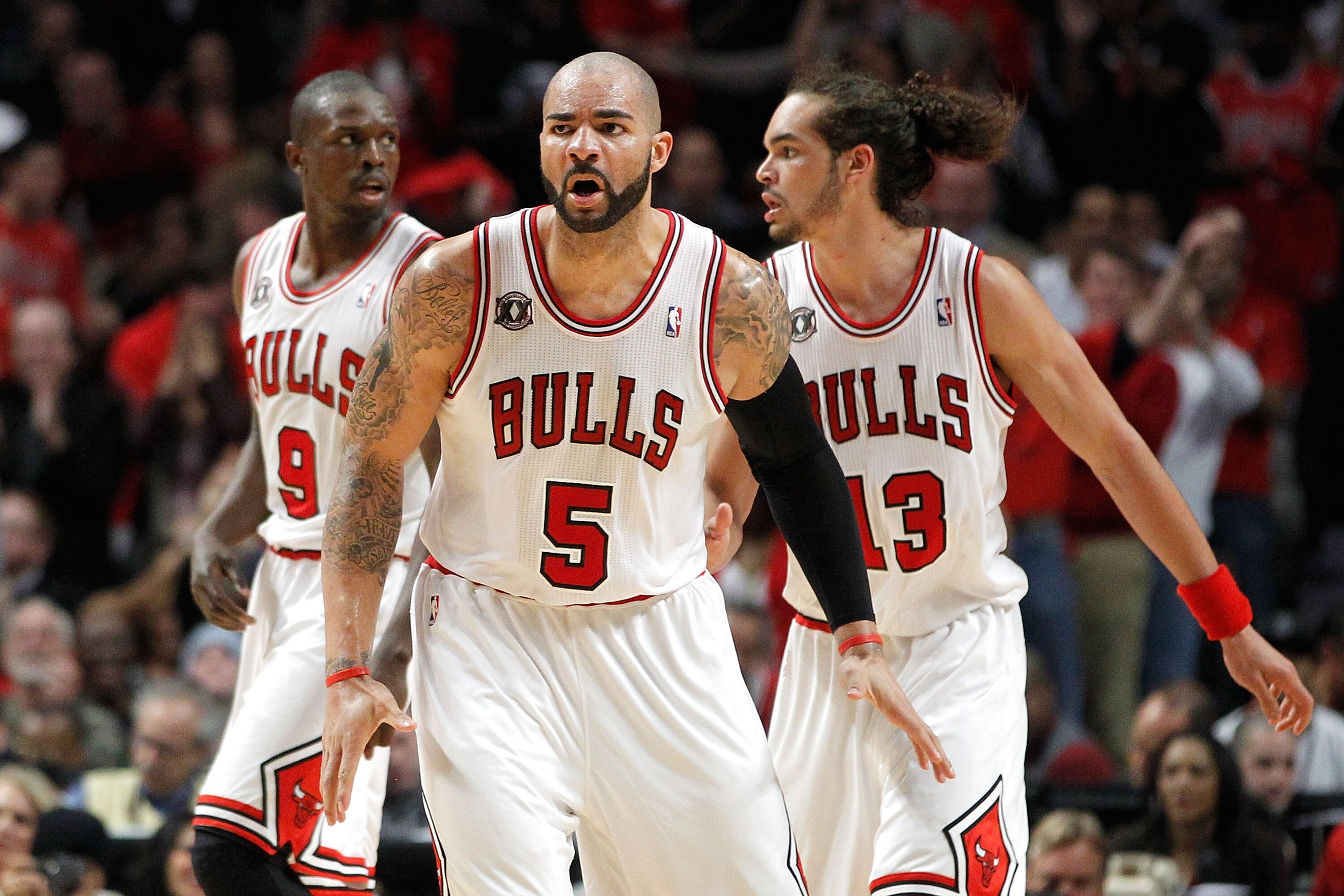 CHICAGO, IL - MAY 15:  (L-R) Luol Deng #9, Carlos Boozer #5 and Joakim Noah #13 of the Chicago Bulls get back on defense against the Miami Heat in Game One of the Eastern Conference Finals during the 2011 NBA Playoffs on May 15, 2011 at the United Center