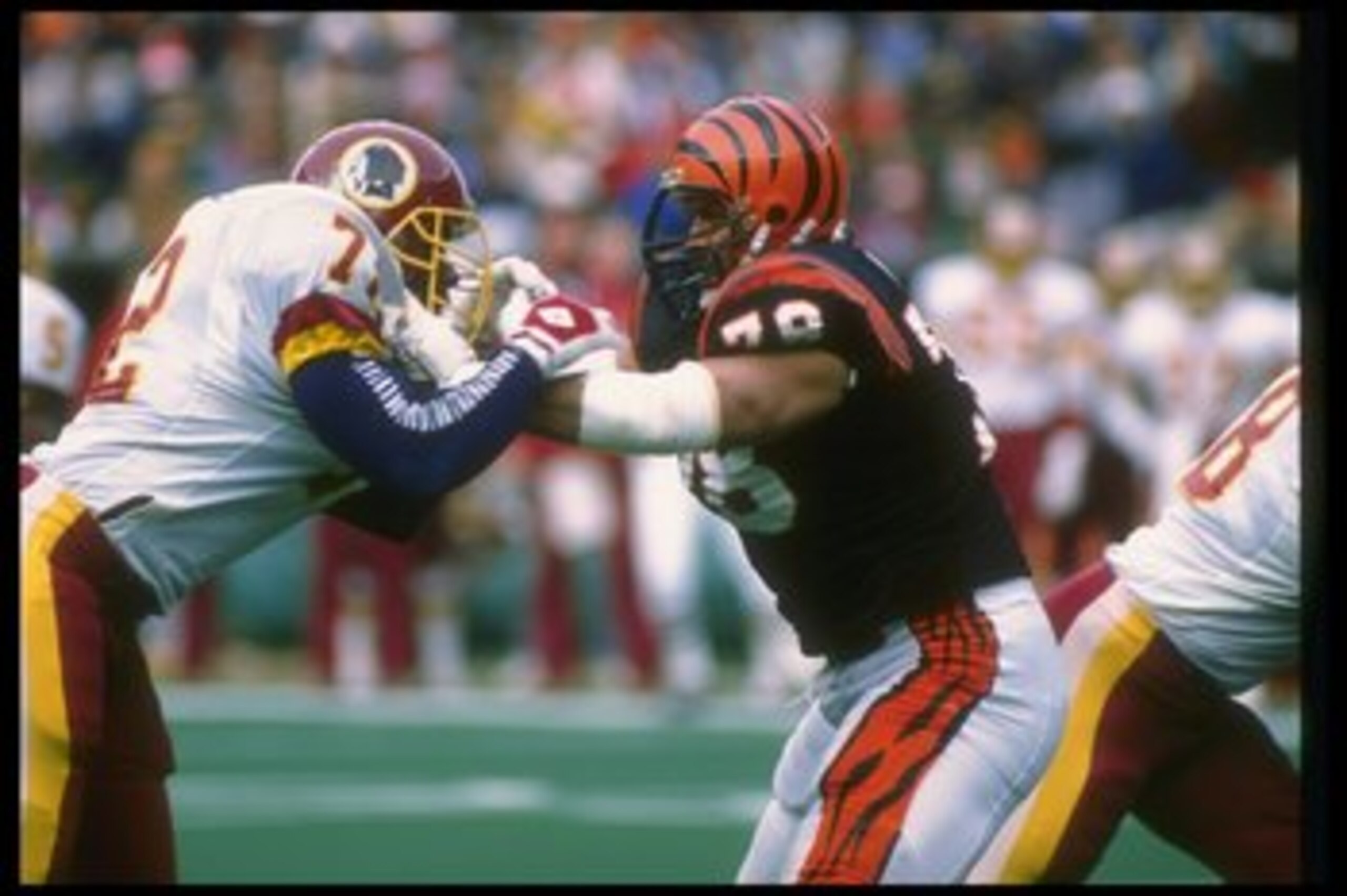 17 Dec 1988:  Offensive lineman Anthony Munoz of the Cincinnati Bengals (right) works against Washington Redskins defensive lineman Dexter Manley during a game at Riverfront Stadium in Cincinnati, Ohio.  The Bengals won the game, 20-17. Mandatory Credit: